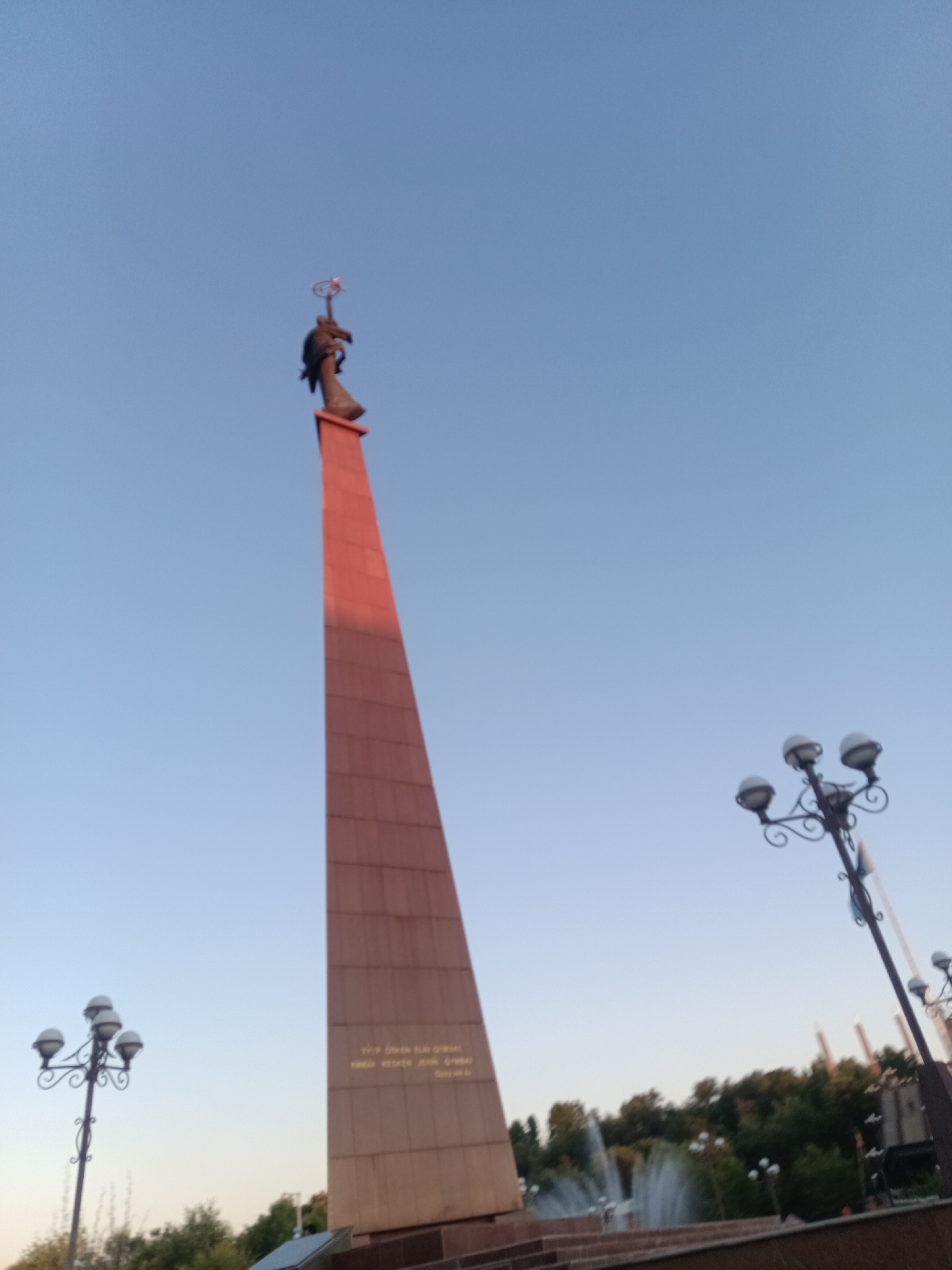 Driving through central Shymkent past monuments and fountains