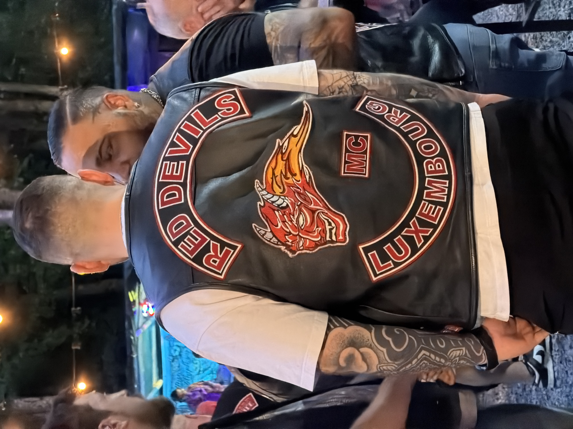 Motorcycle club crowd at an outdoor dusk concert in Luxembourg