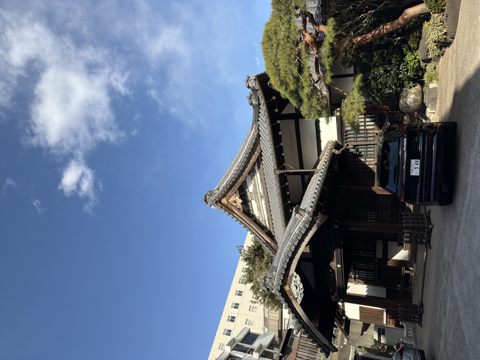 Traditional temple stands amid modern Shibuya streetscape