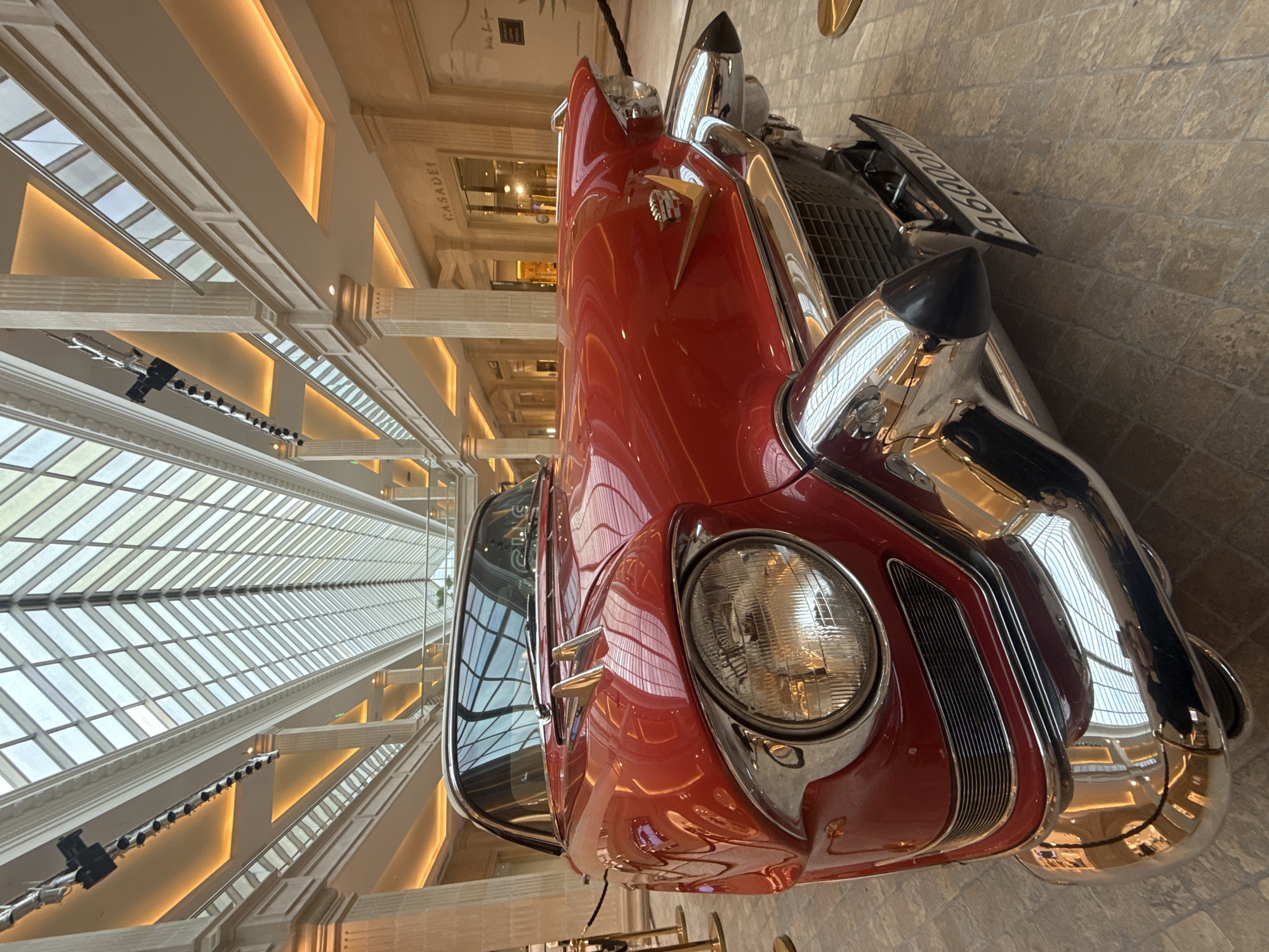 Red classic car parked indoors in Khimki, chrome details on display