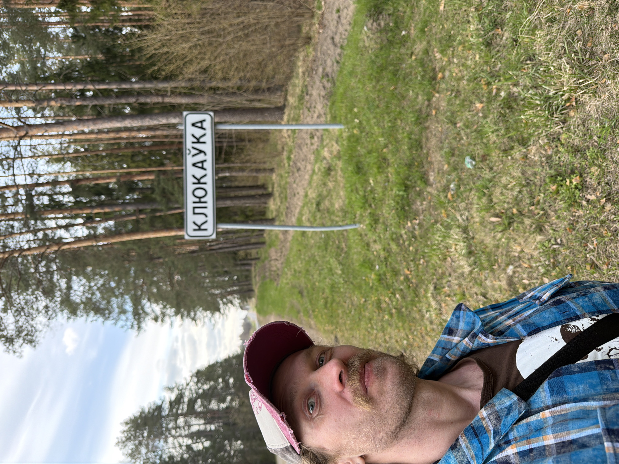 Rural Belarus scenes captured: man, cars, forest road