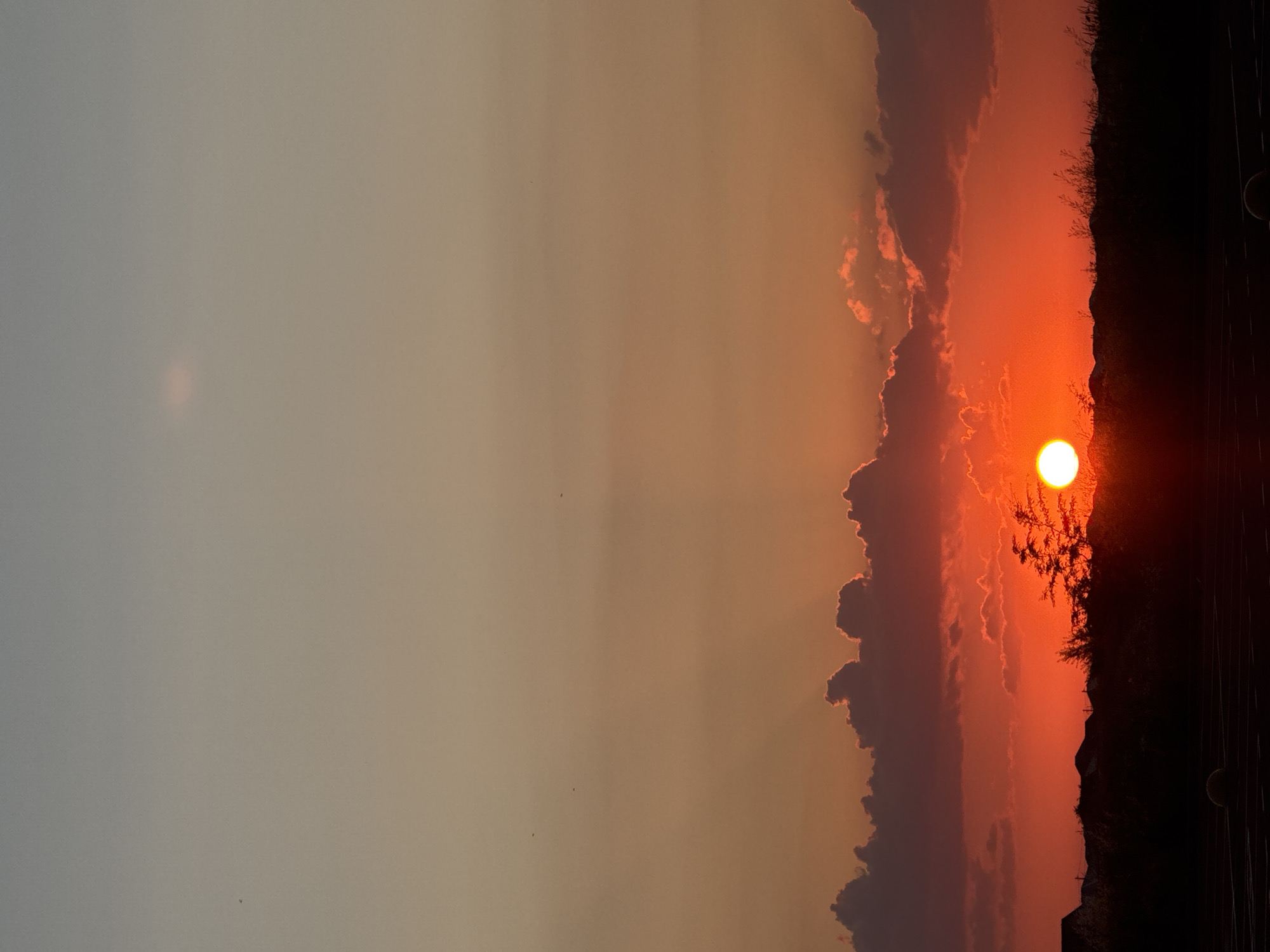 Sunset through clouds and silhouettes, caught from multiple angles