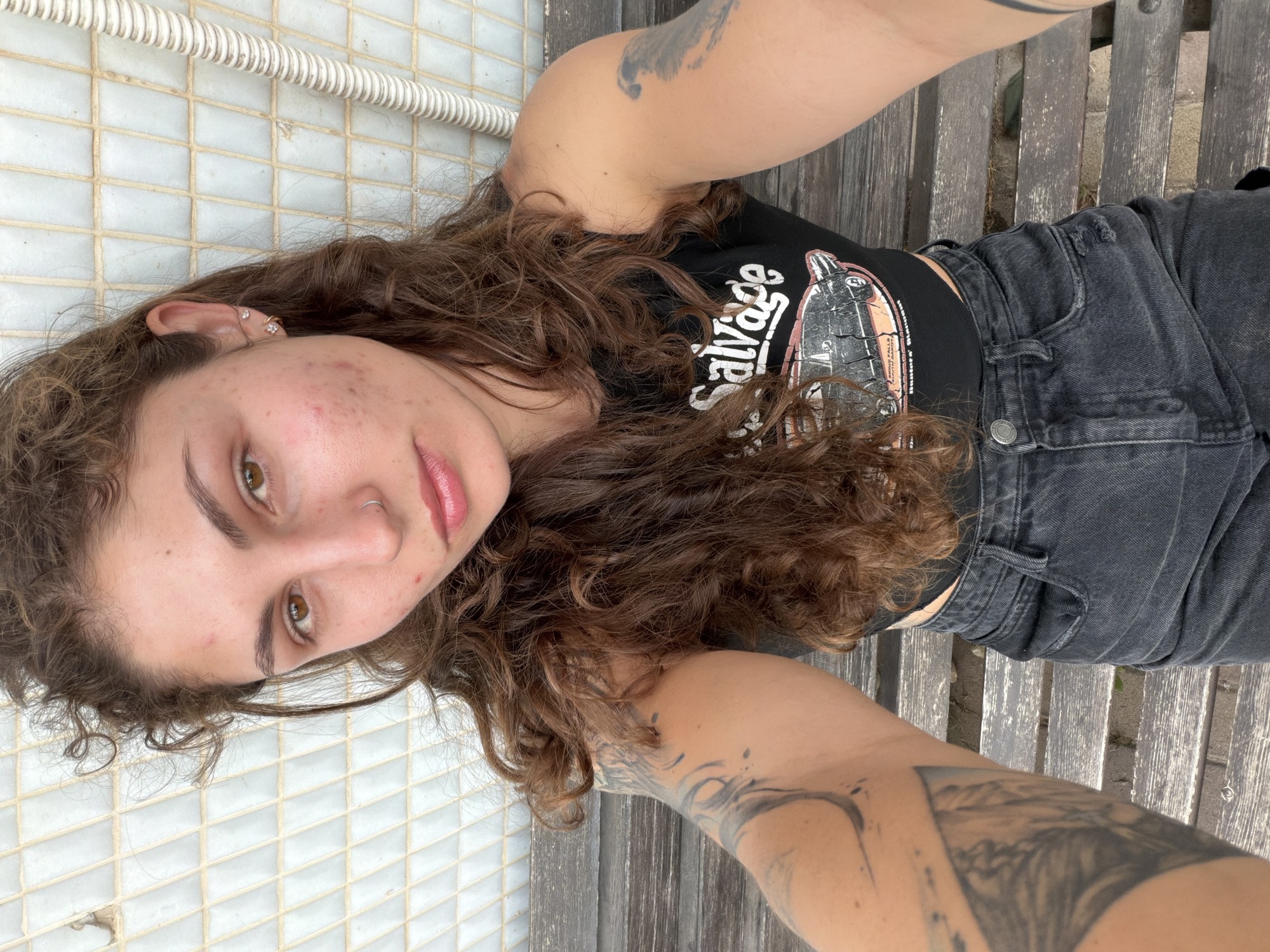 Woman rests on bench in Kiryat Bialik