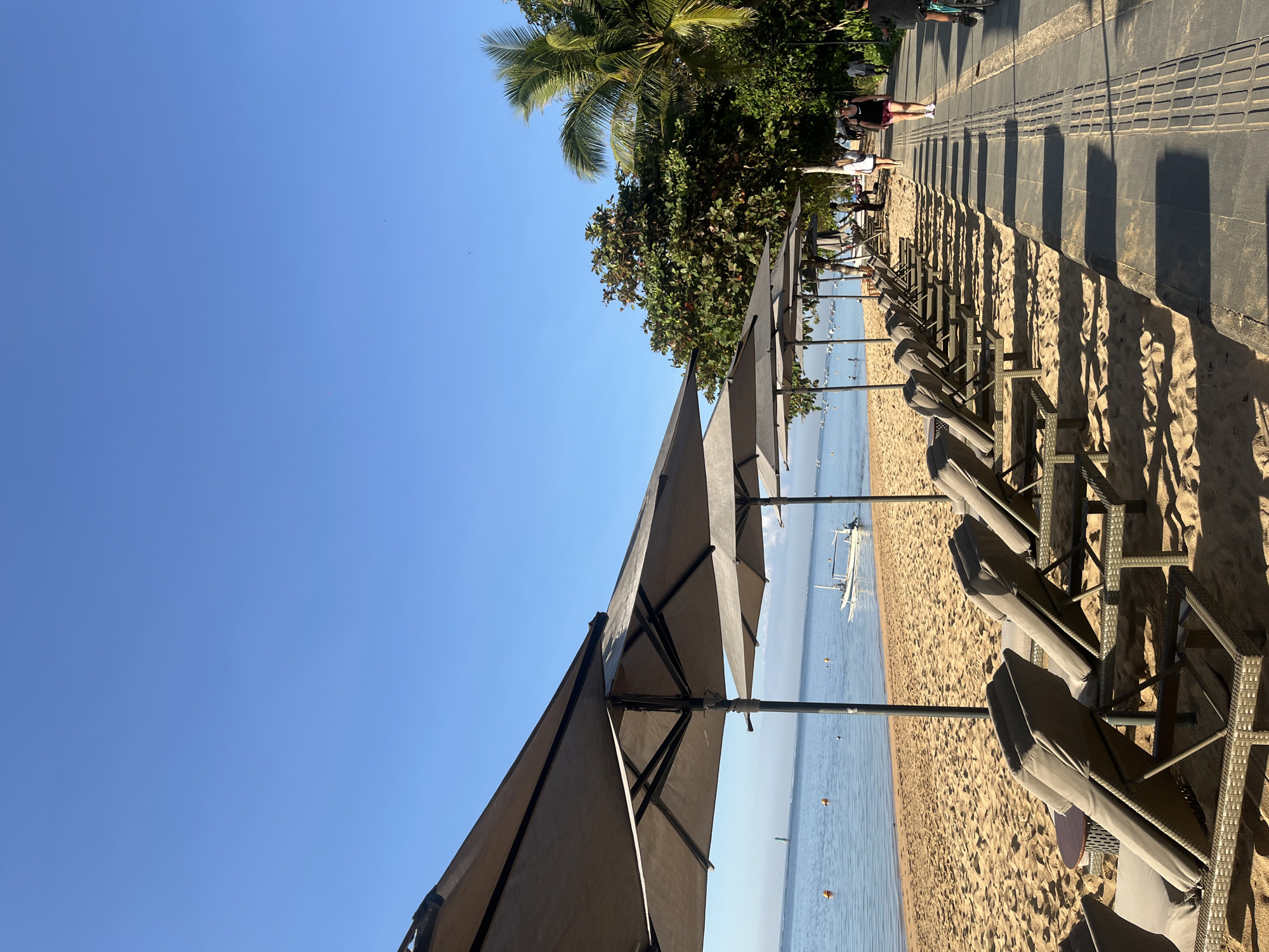 Sanur Beach on a busy, sun-filled afternoon in Denpasar