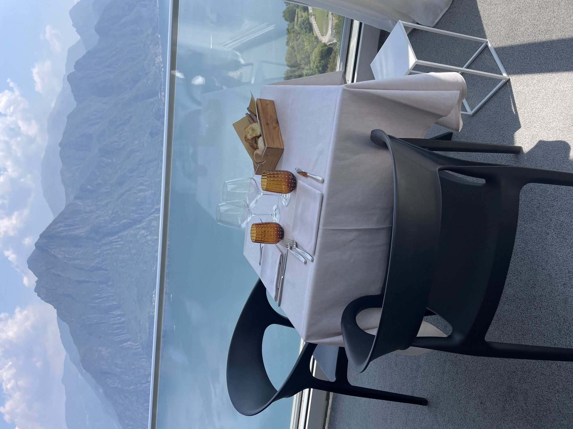 Romantic table setting overlooks mountain lake in Zorzino