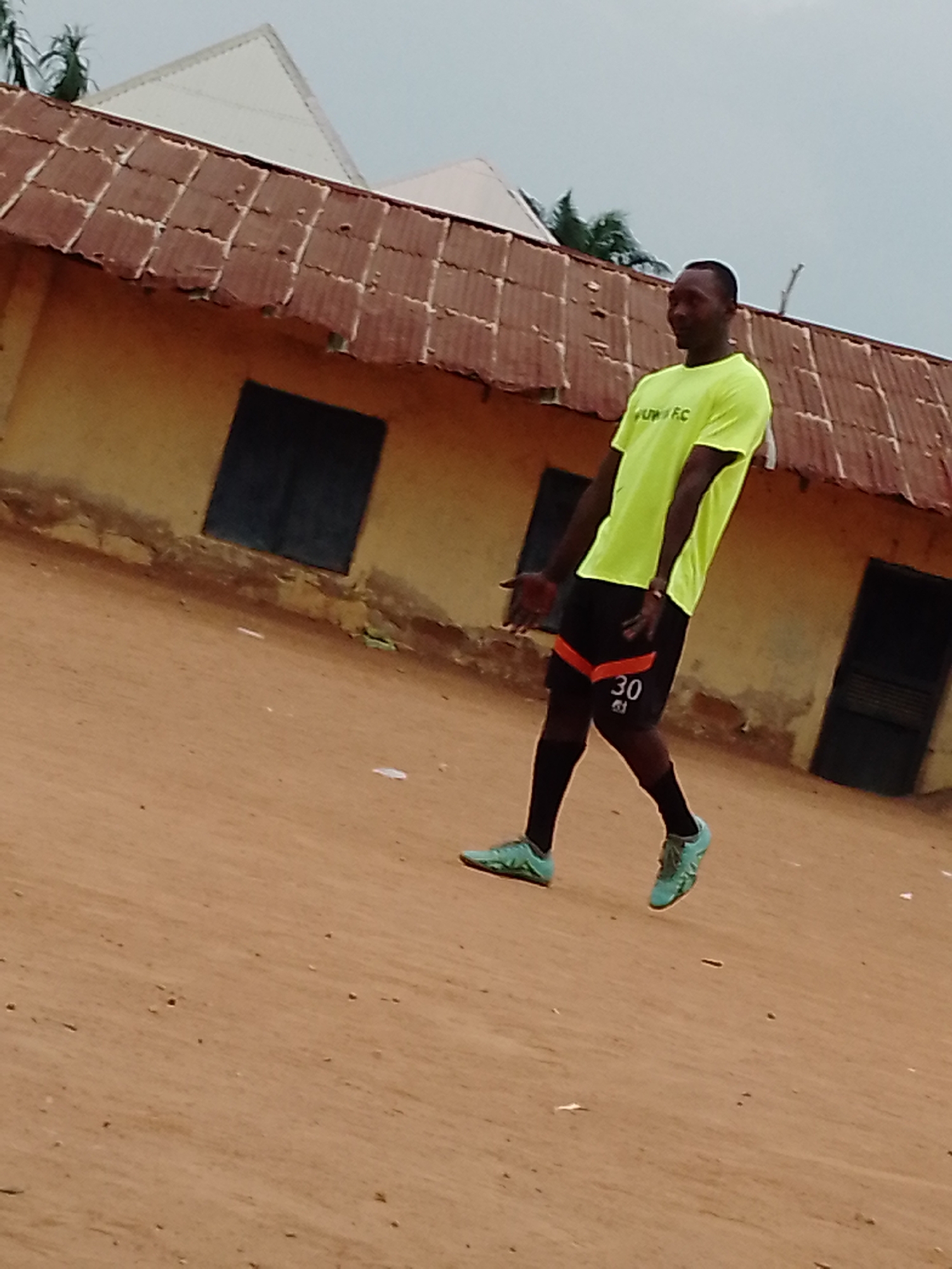 Pickup soccer game draws players and spectators to dirt field