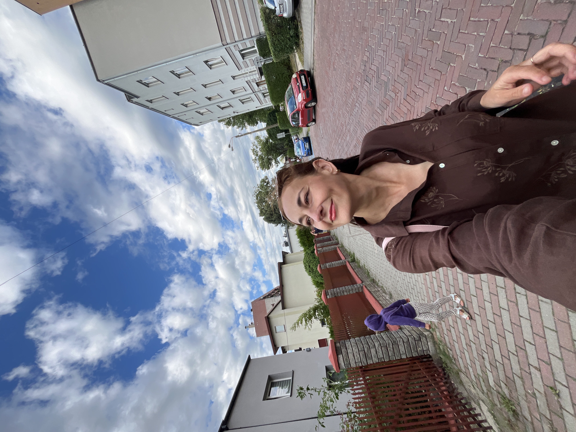 Selfies and street scenes along a neighborhood walk under cloudy skies
