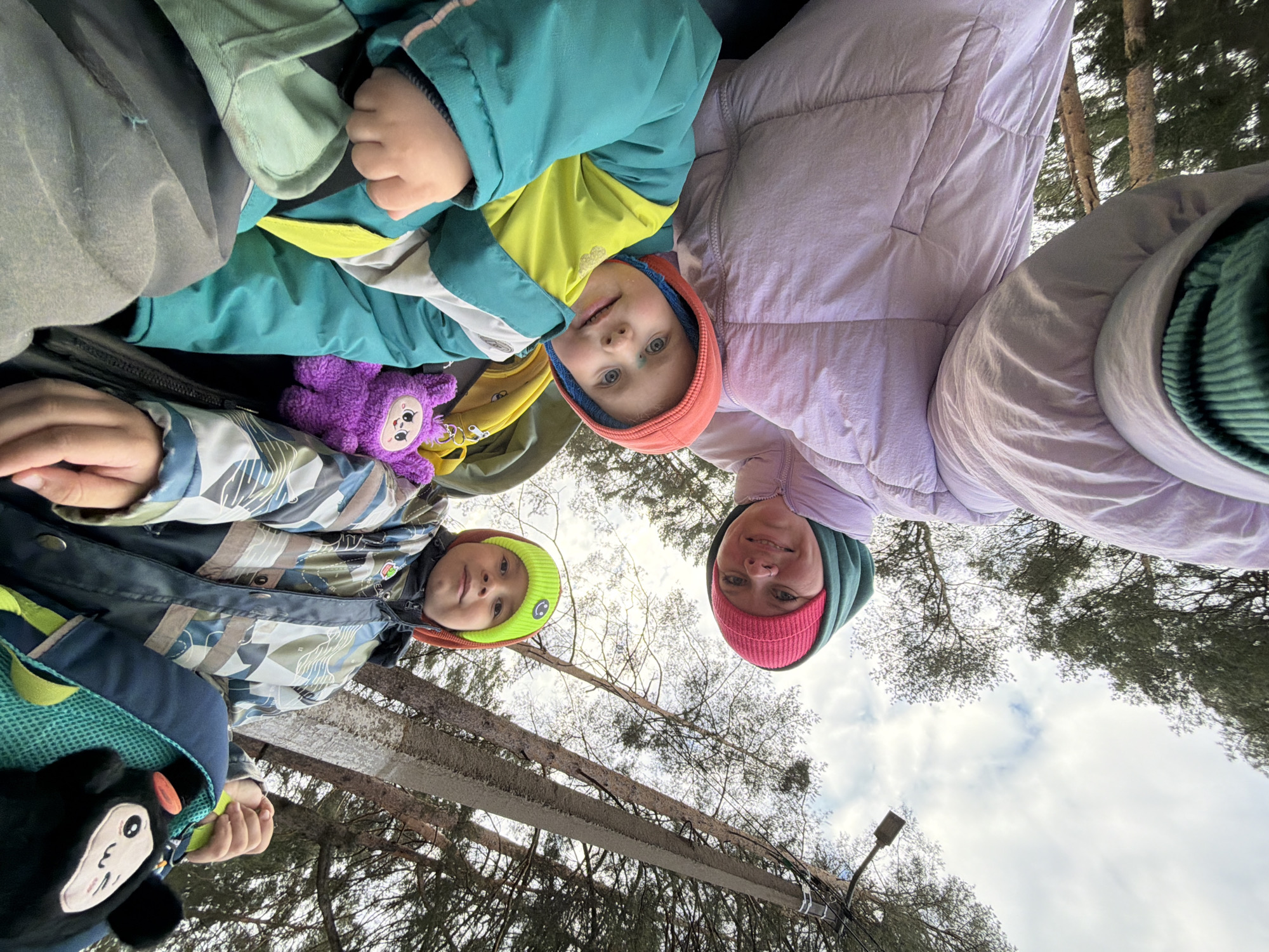 Family moment captured near wooded waterside in Chaikovsky, Russia