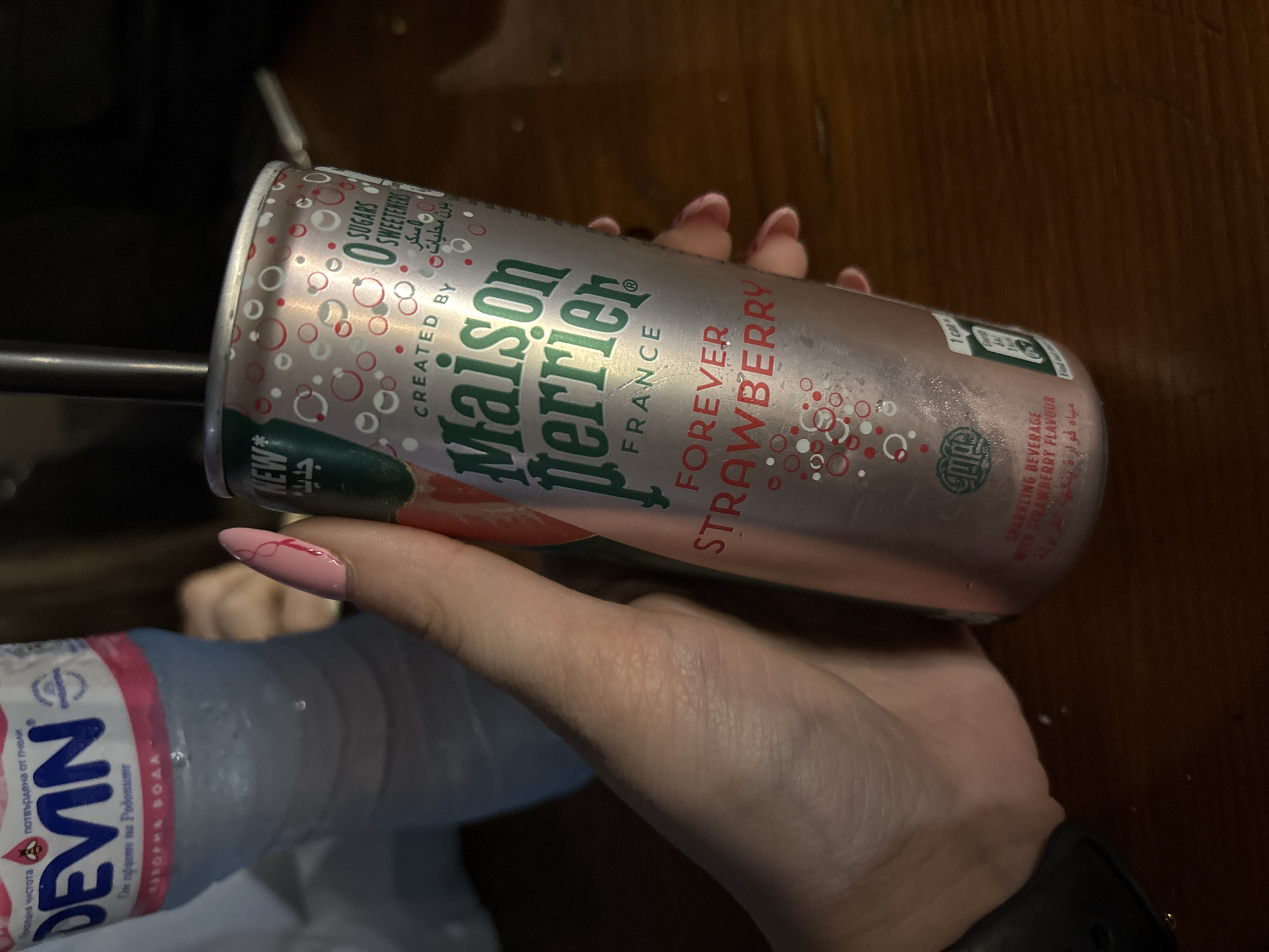 Person holds sparkling drink and water in Bulgarian town