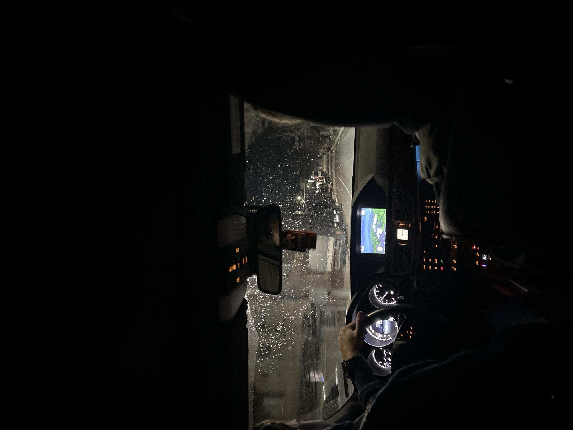 Driver navigates rainy night roads in Marchevo, Bulgaria