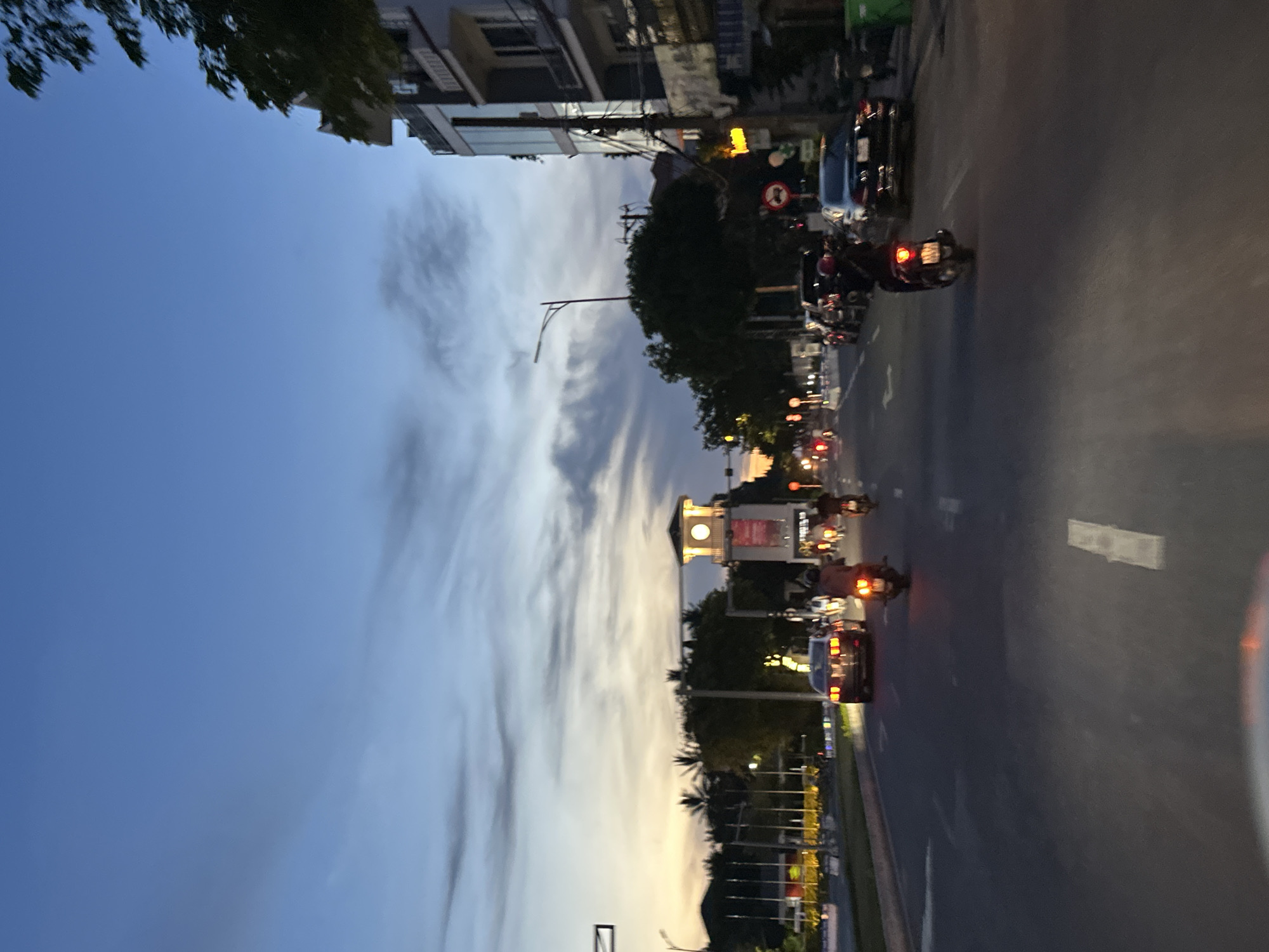 Da Nang intersection at dusk, traffic flowing under twilight skies