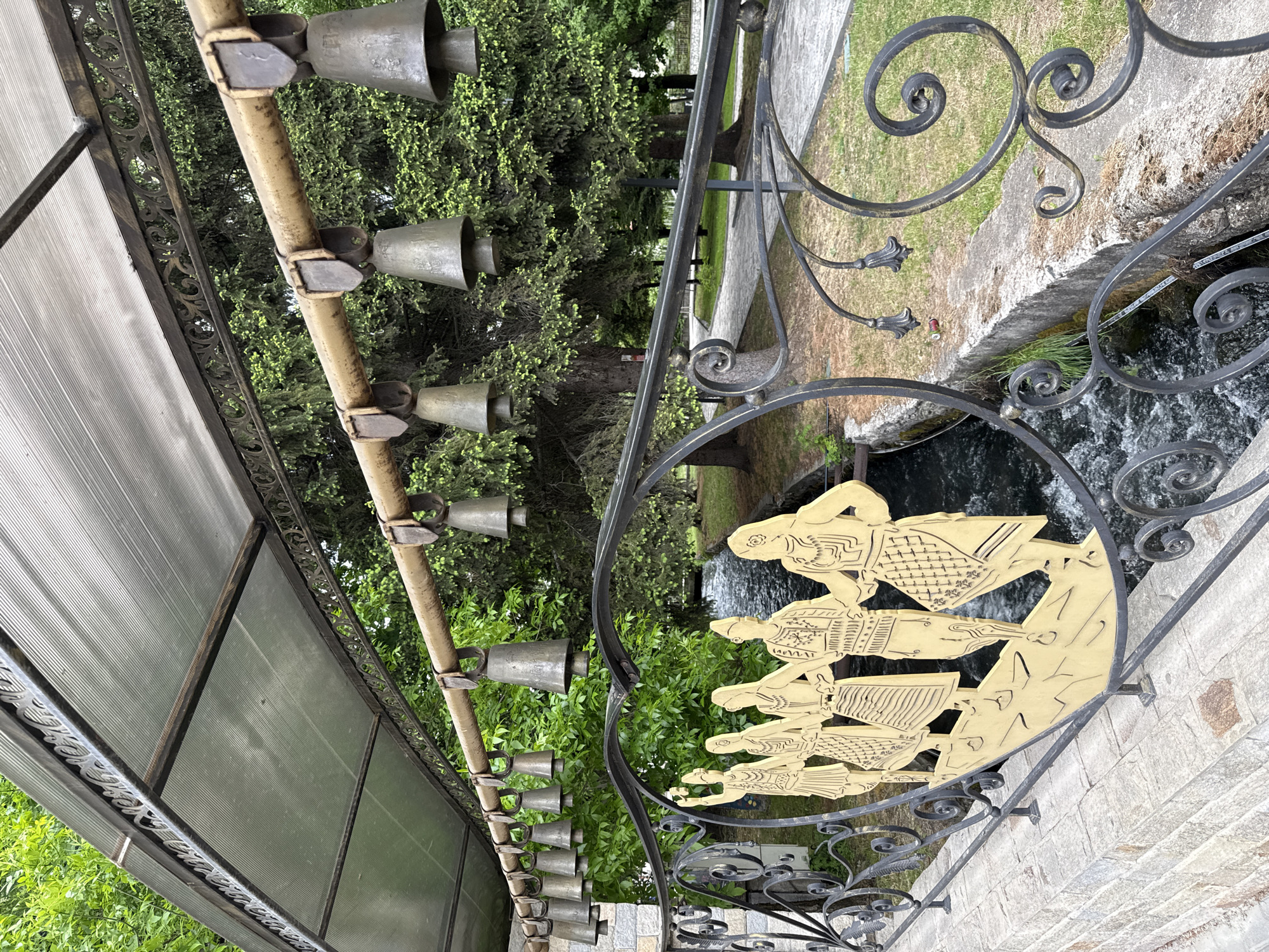 Tourist rings traditional cowbells at decorated display in Razlog
