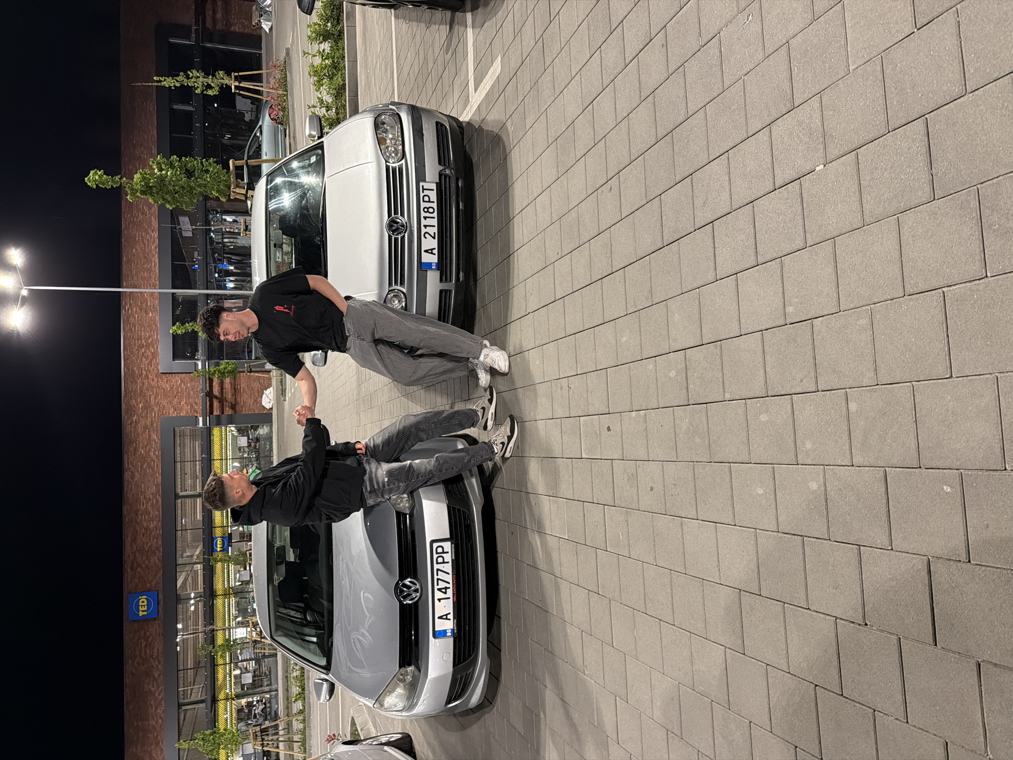 Young men pose on cars in Burgas parking lot