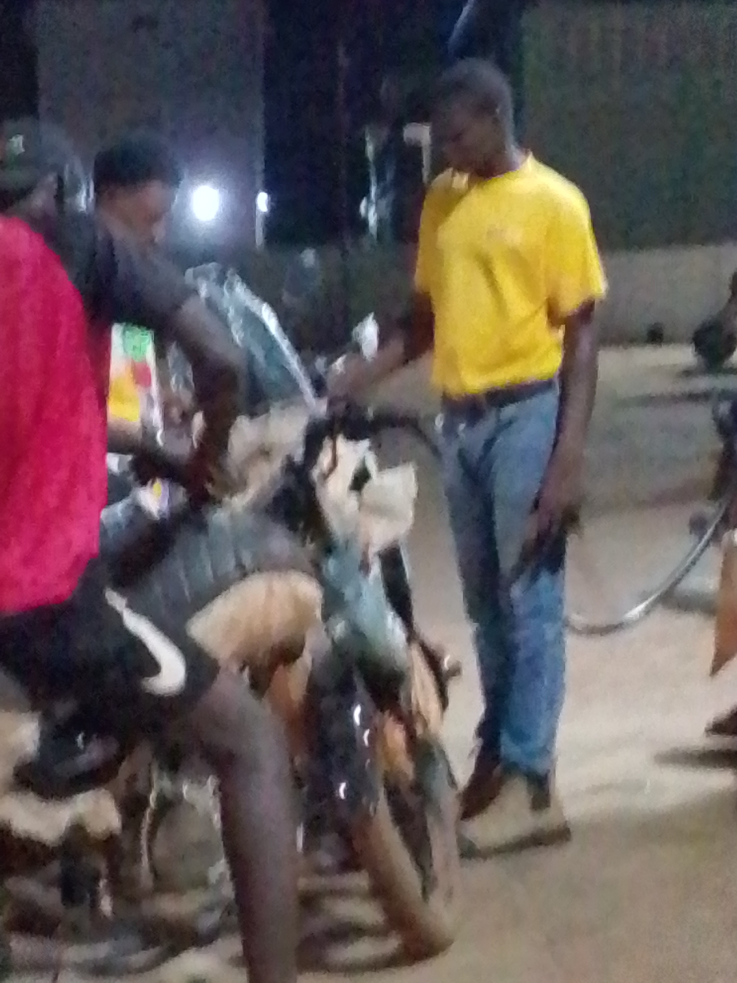 Damaged motorcycle draws crowd at Tamale gas station