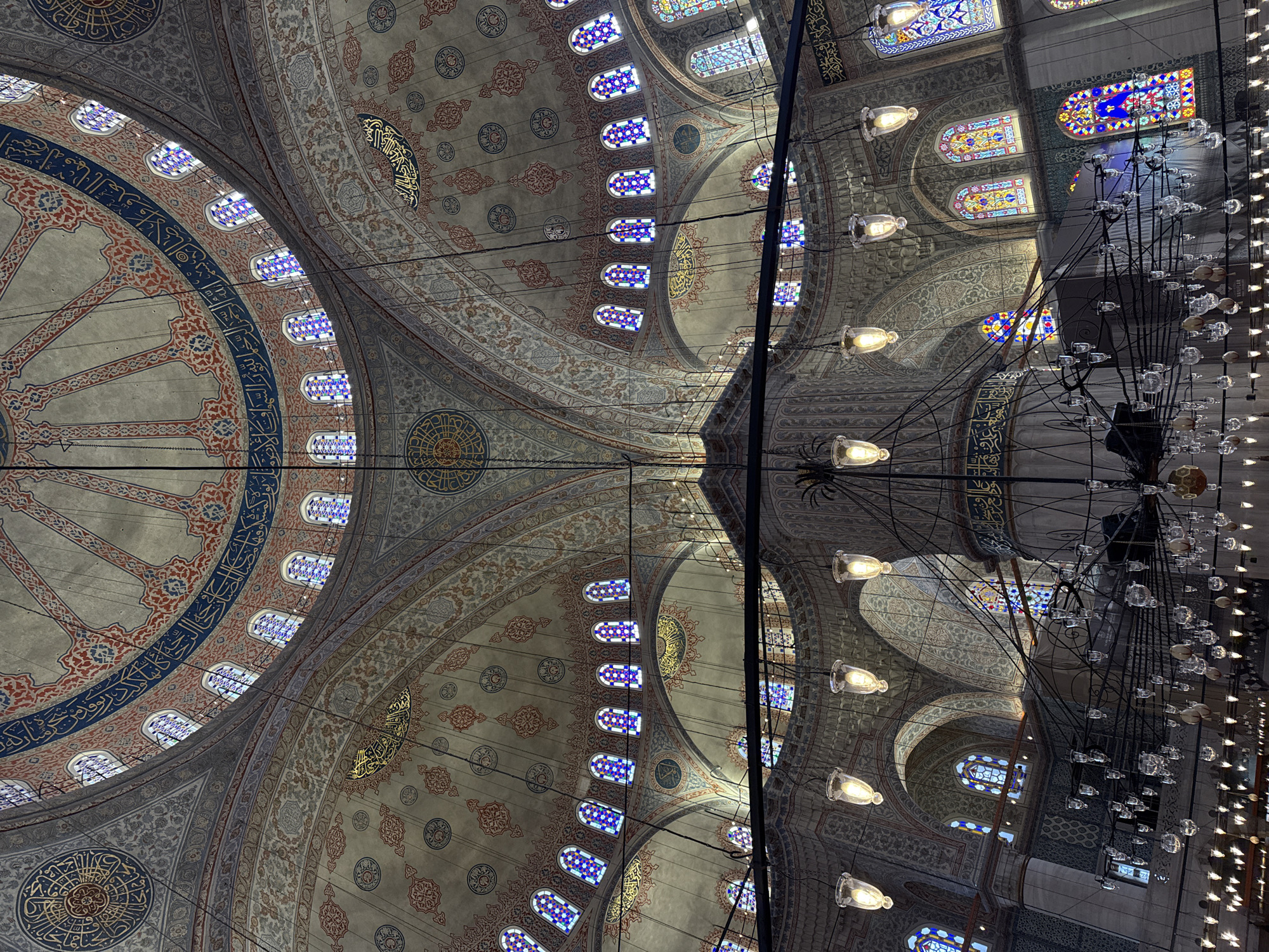 Morning tourists photograph Blue Mosque interior and exterior in Istanbul