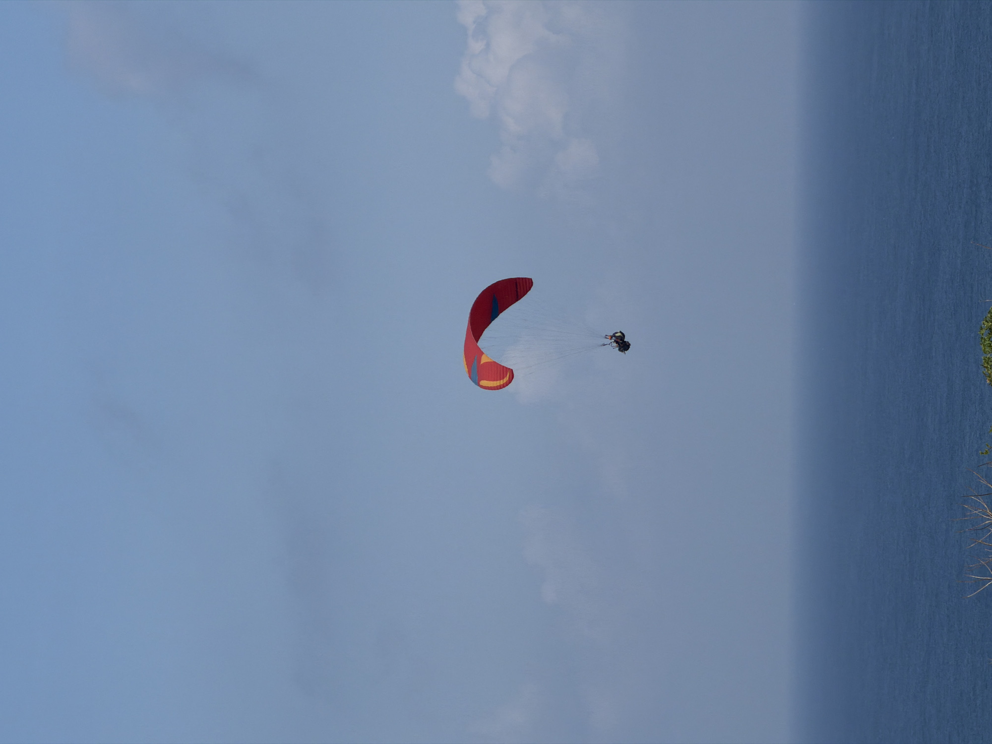 Paragliders over the Bali coast, construction work below