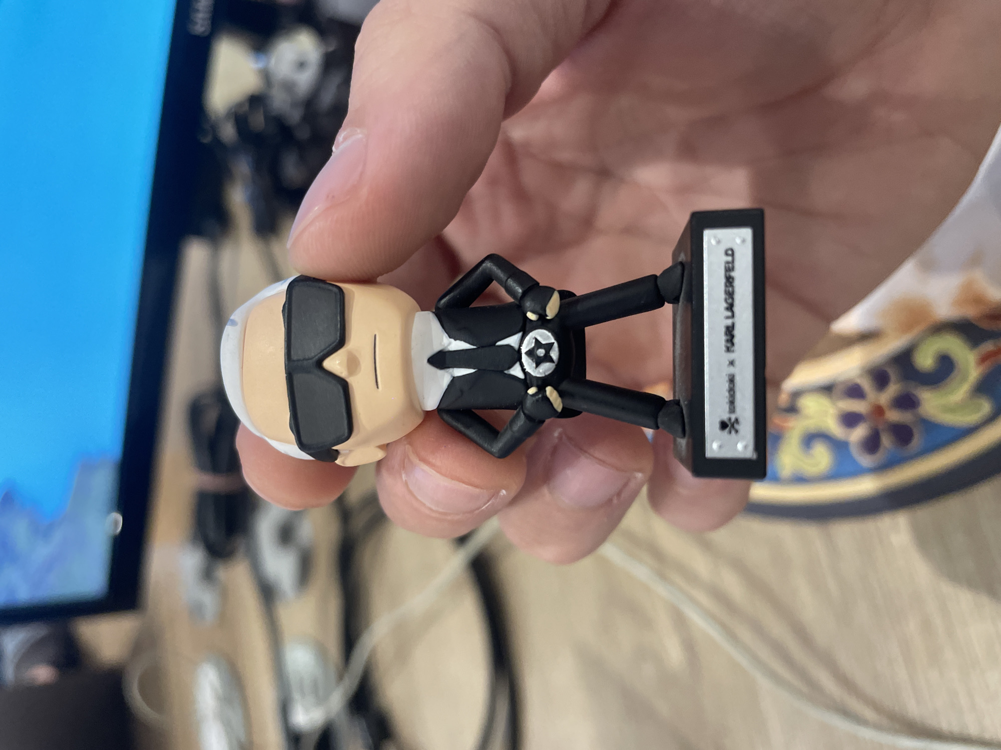 Mexico City resident handles designer figurine during laptop session