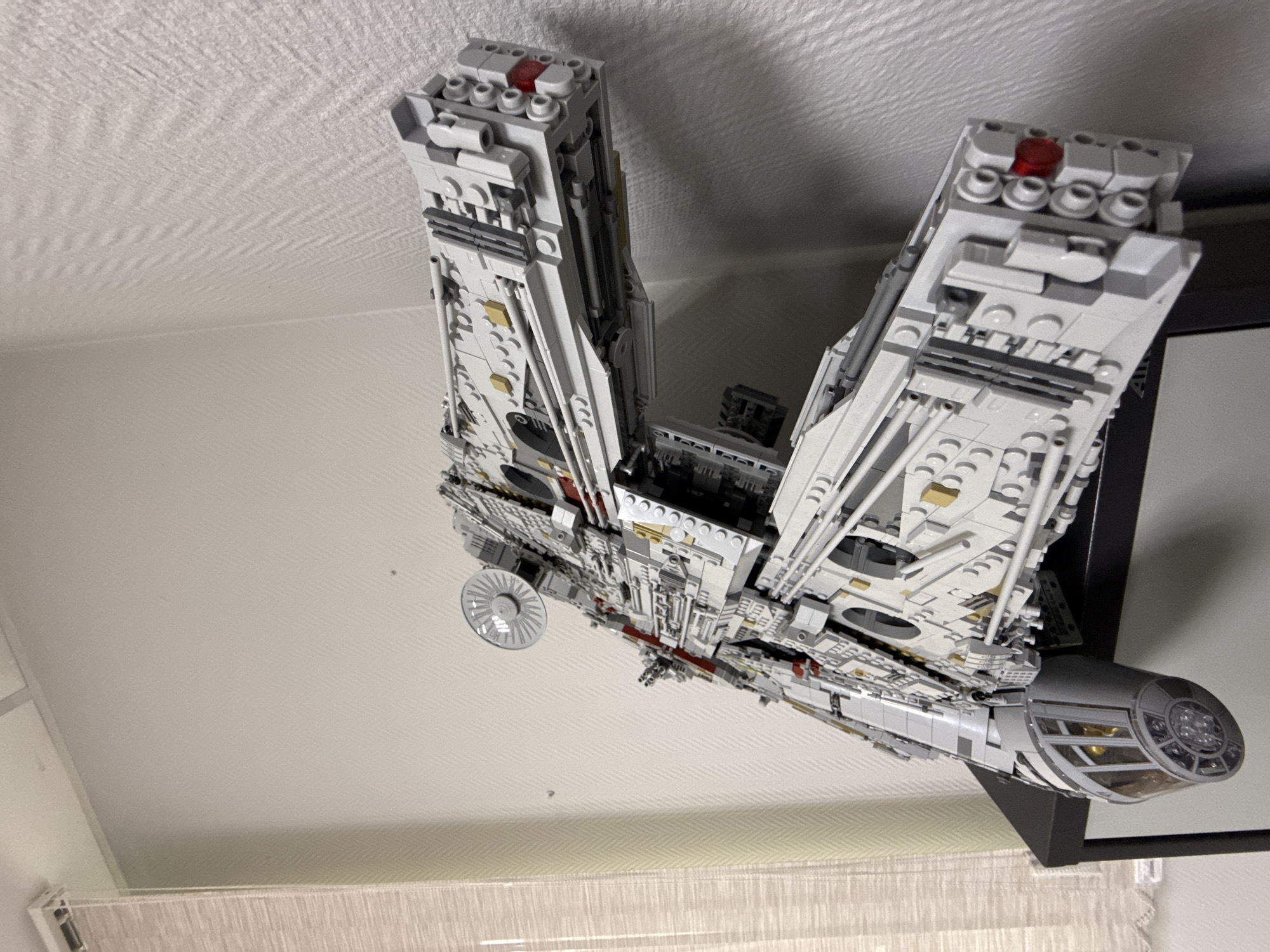 LEGO Millennium Falcon model displayed on wall in Krasnoyarsk
