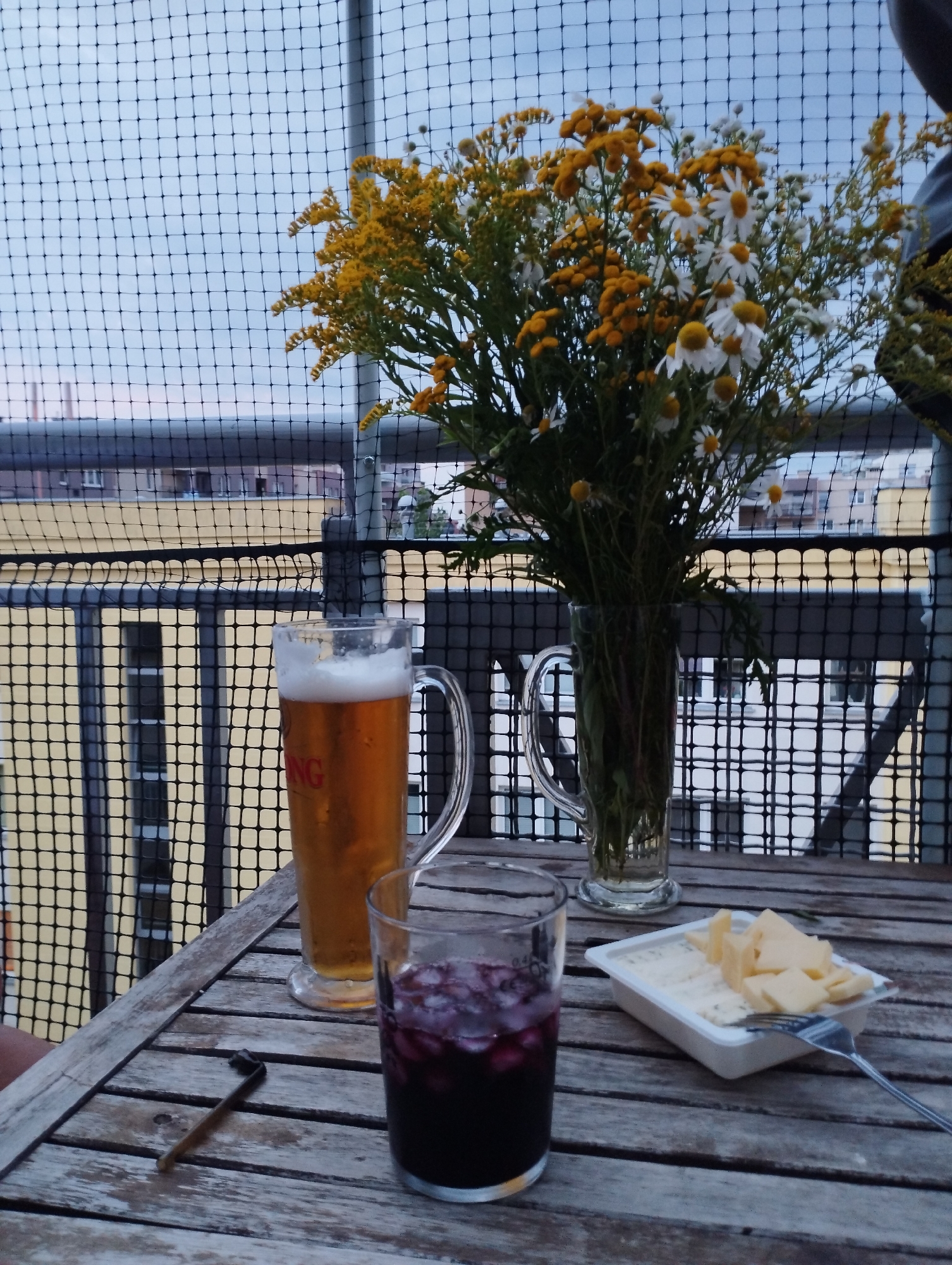 Balcony drinks and a relaxed cat on a Warsaw evening