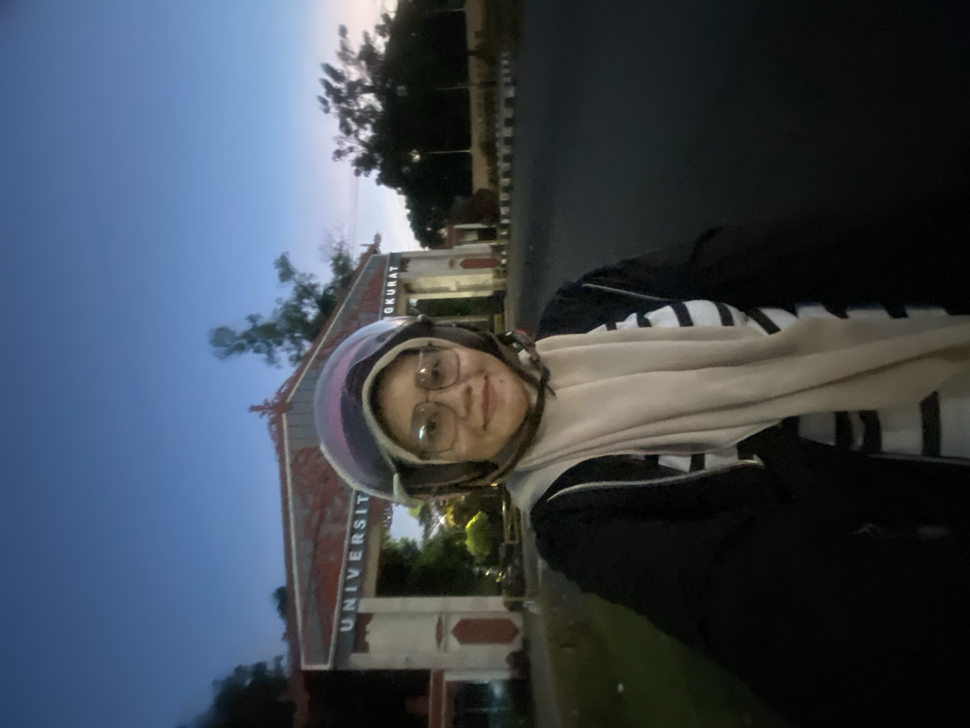 Dusk ride through Banjarbaru's lit landmarks and university gate