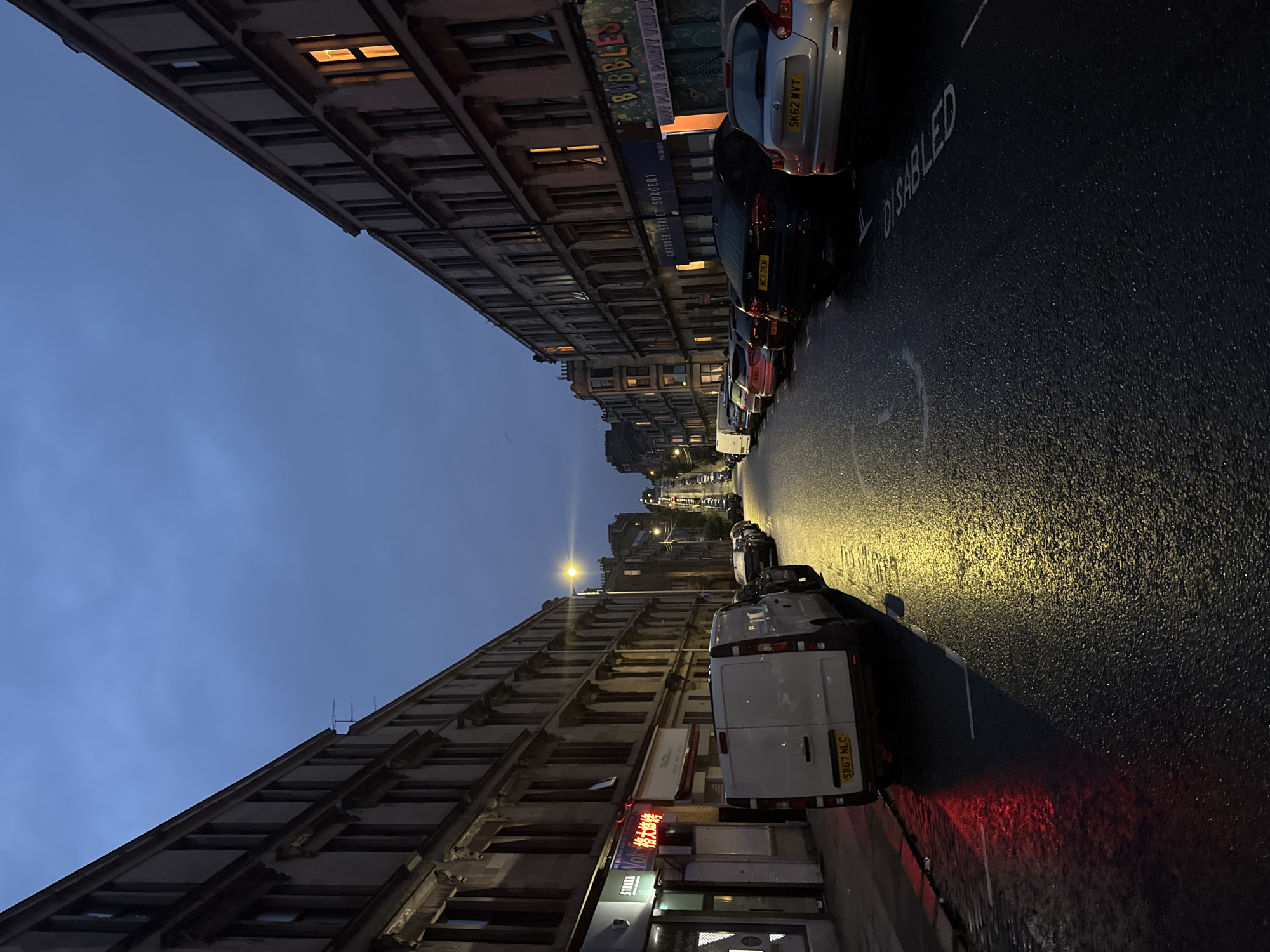 Glasgow tenement street at dusk, deep sky overhead