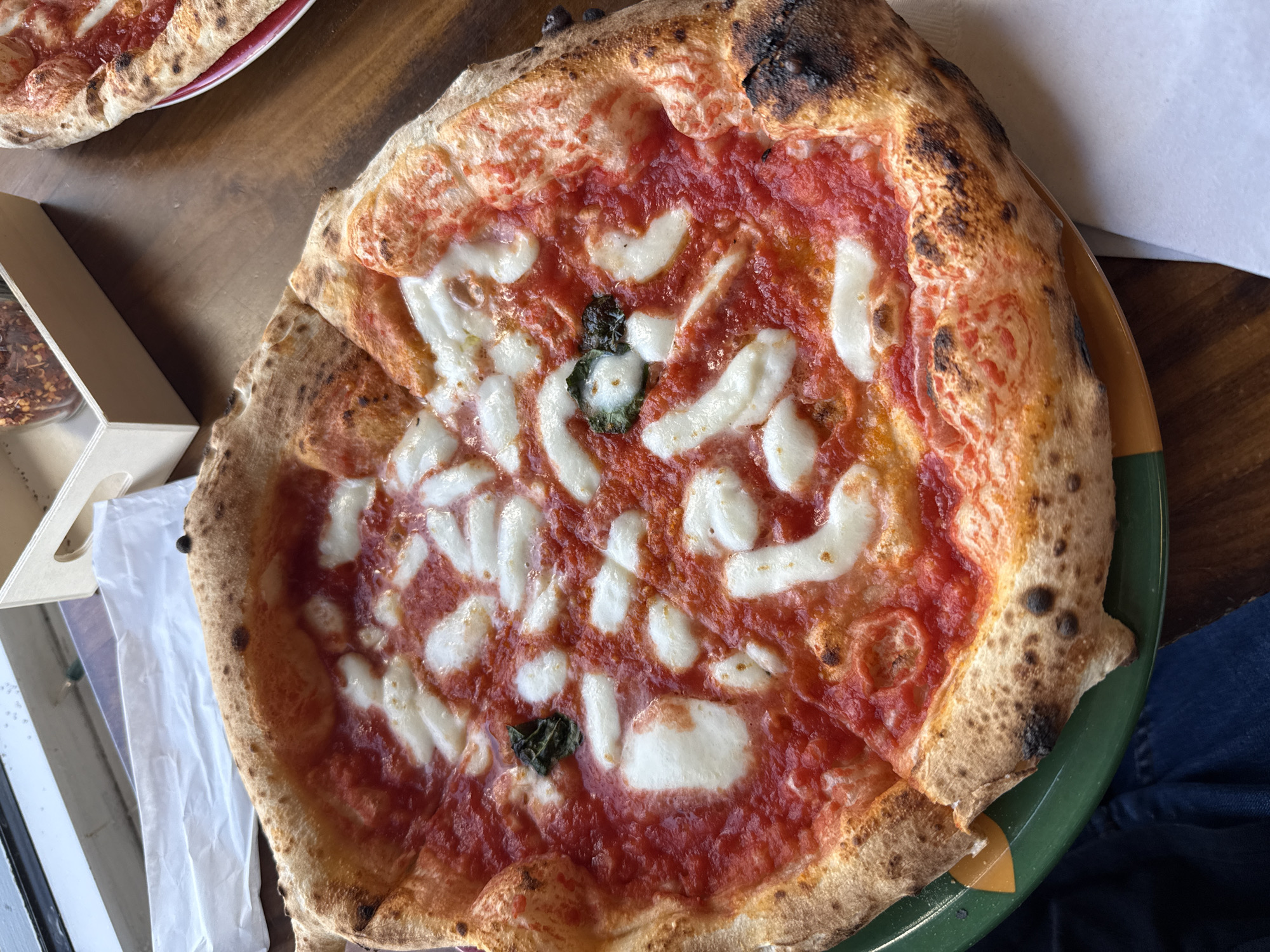 Margherita pizza captured on green plate in Cocoa Beach