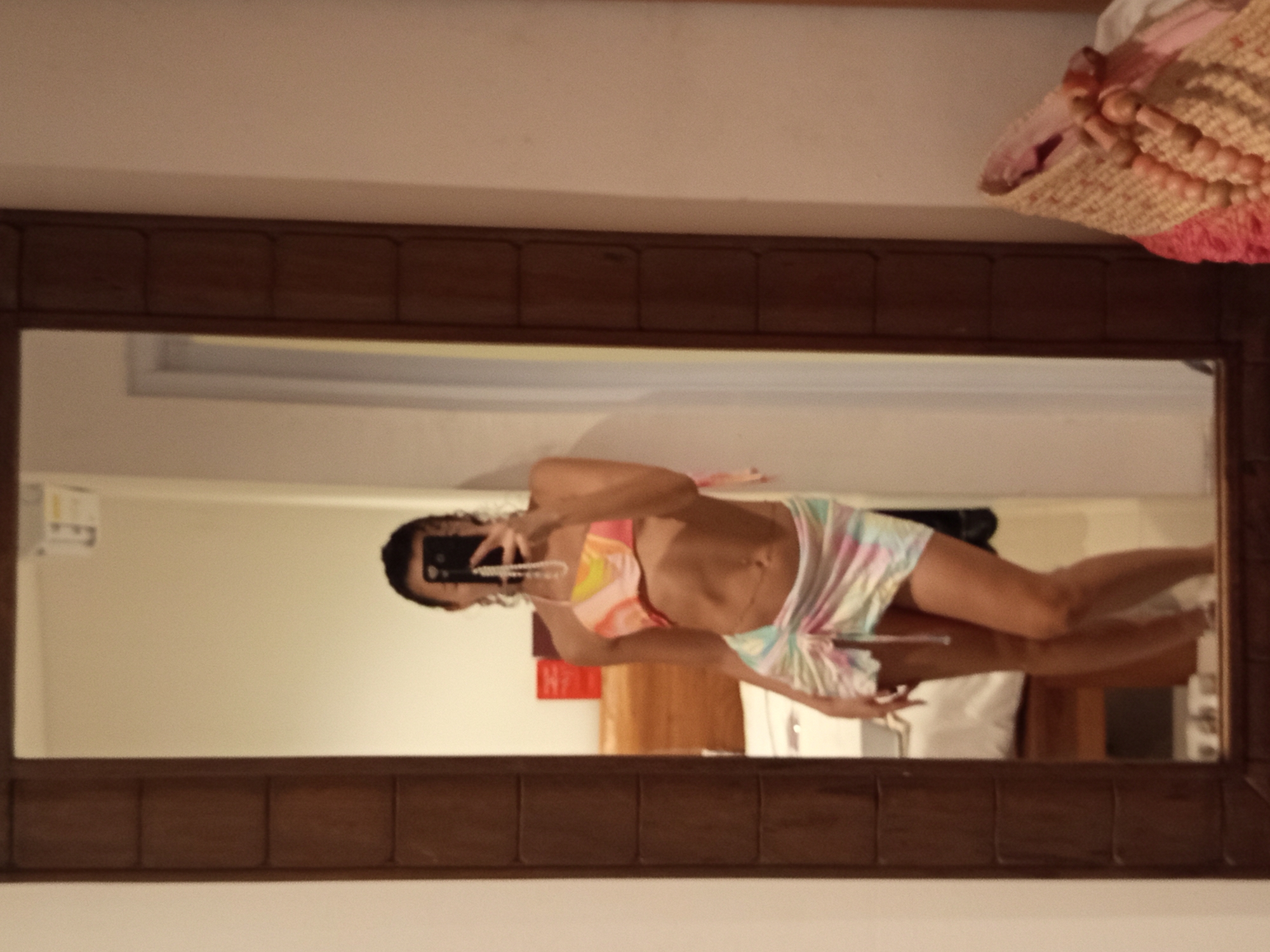 Woman takes mirror selfies in colorful outfit in North Kuta