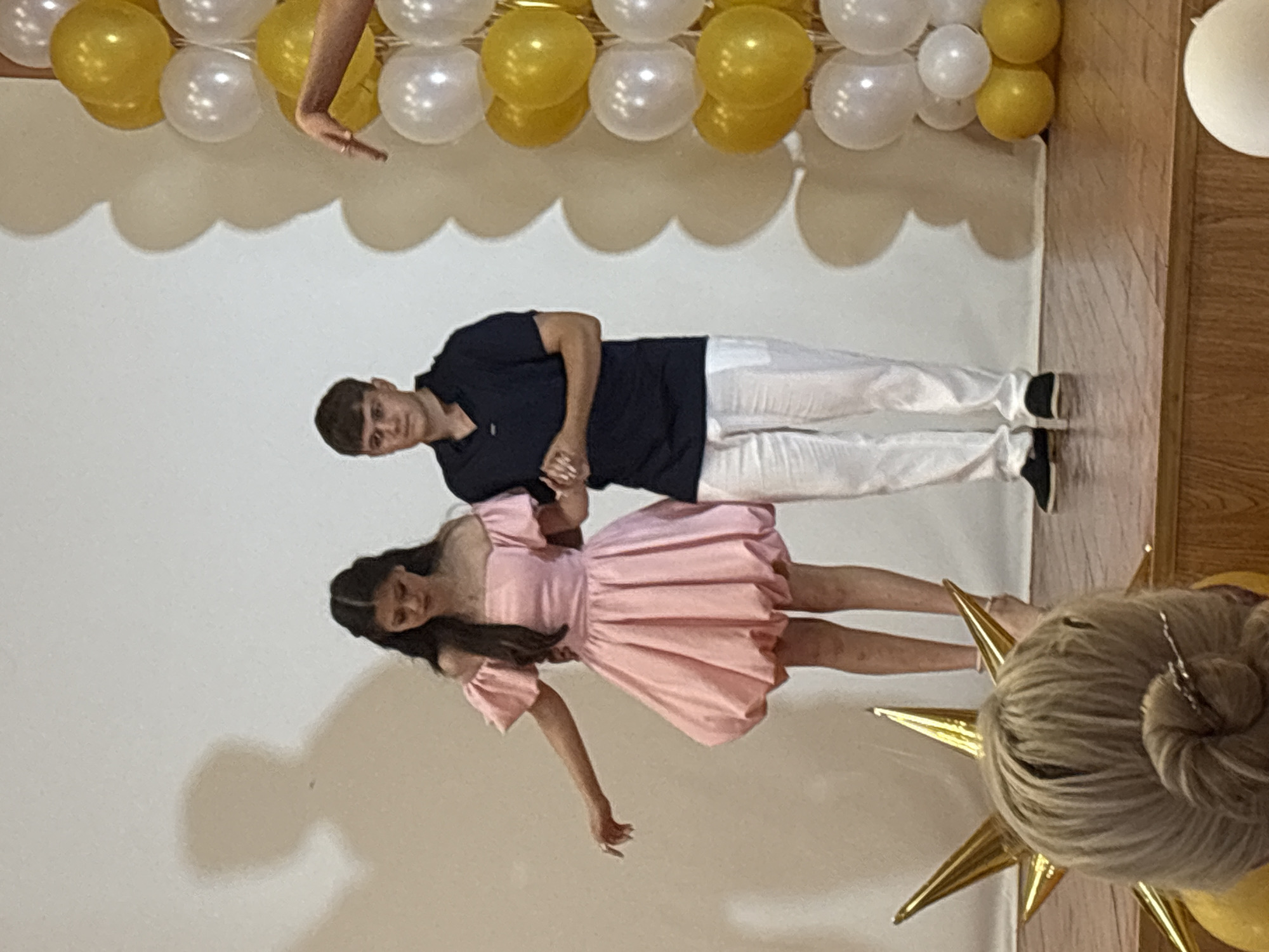 Graduation and awards ceremony with certificates, flowers, and a stage performance