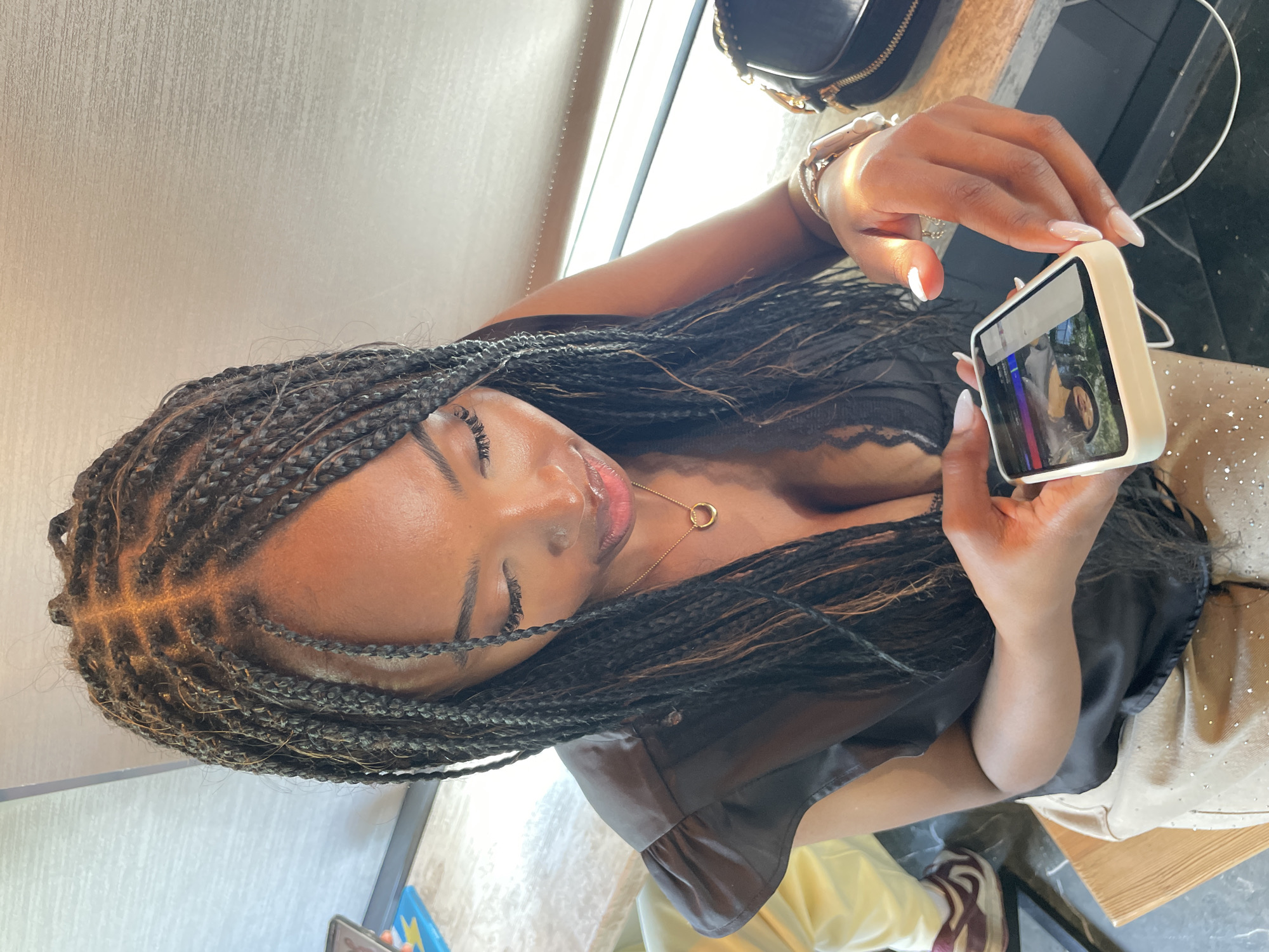 Woman checks phone at cafe during lunch hour
