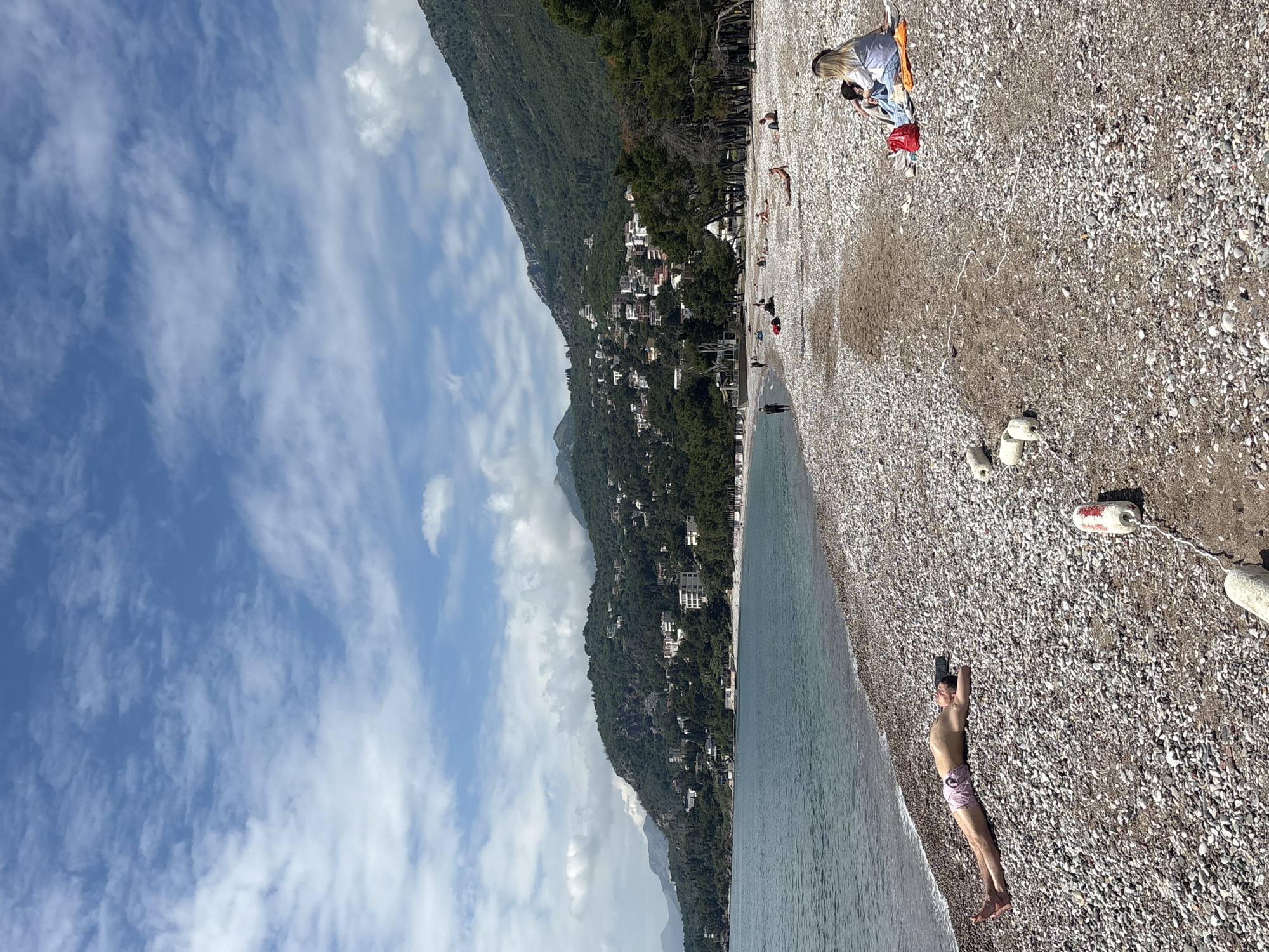 Man visits pebble beach in Bar, Montenegro