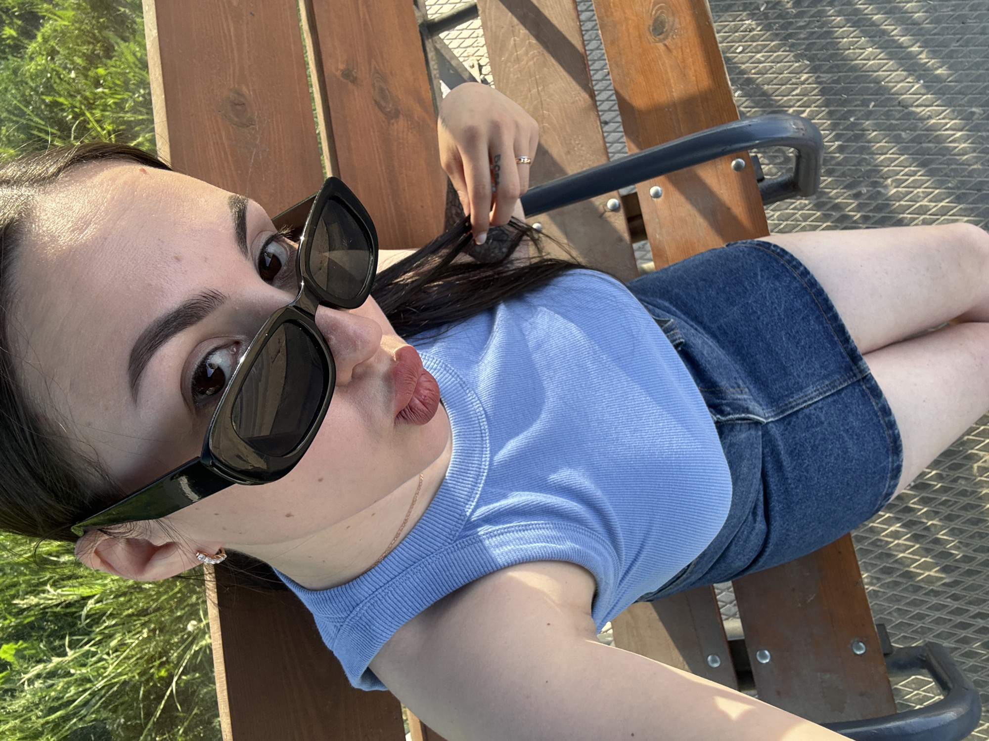 Woman spotted relaxing outdoors, taking mirror selfie in Chaikovsky