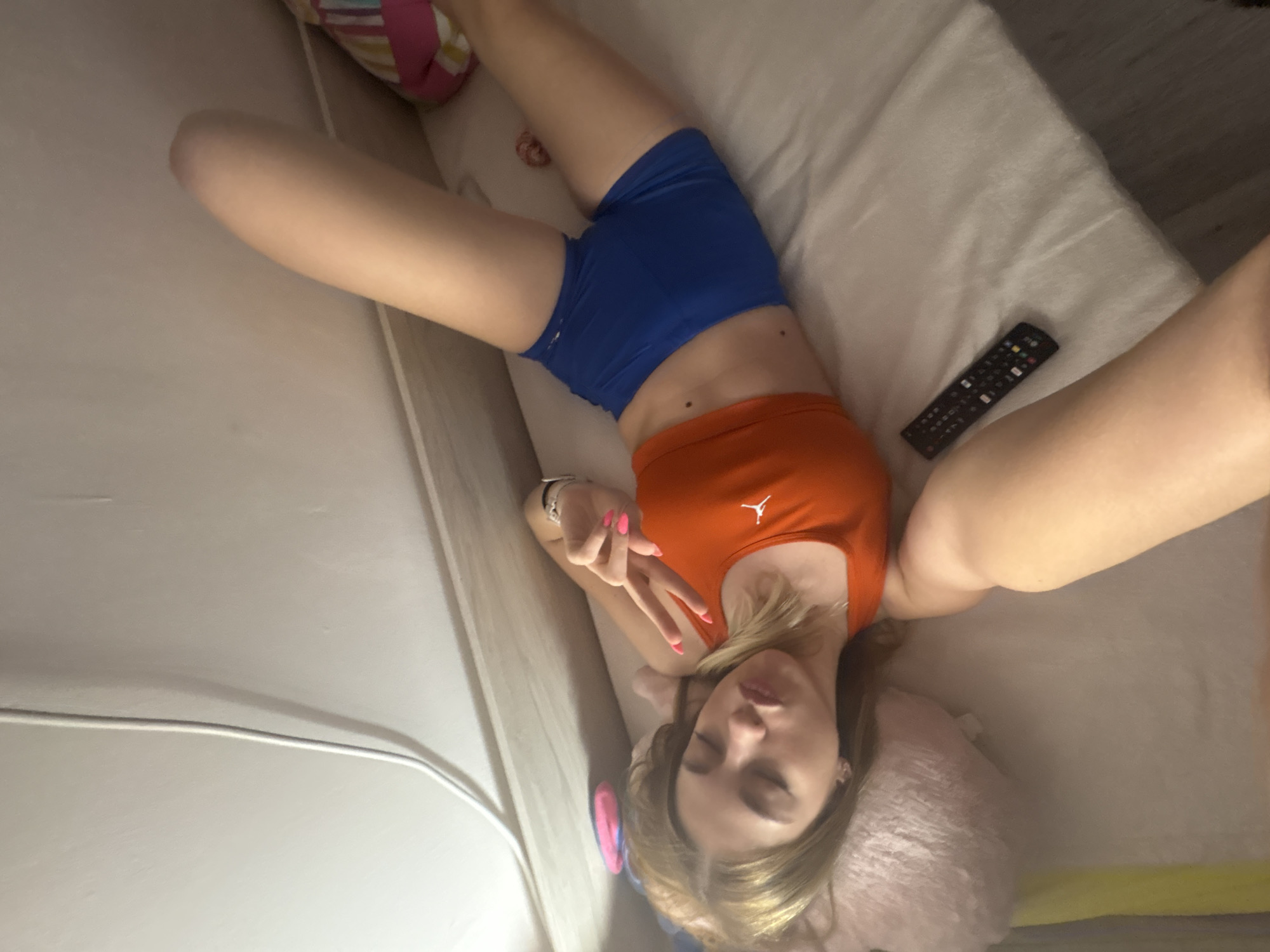 Woman takes selfies in orange Jordan top in Sofia