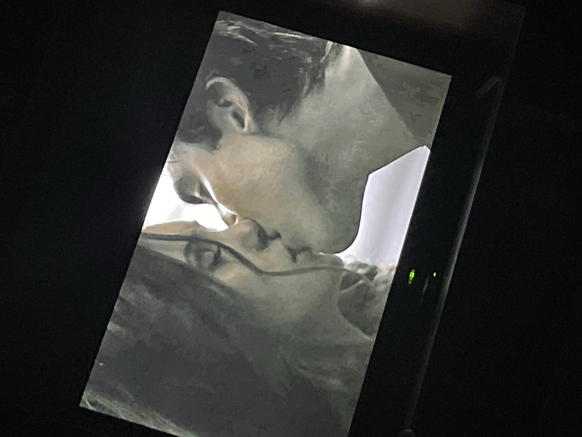 Close-up kiss scene, possibly from a TV or film