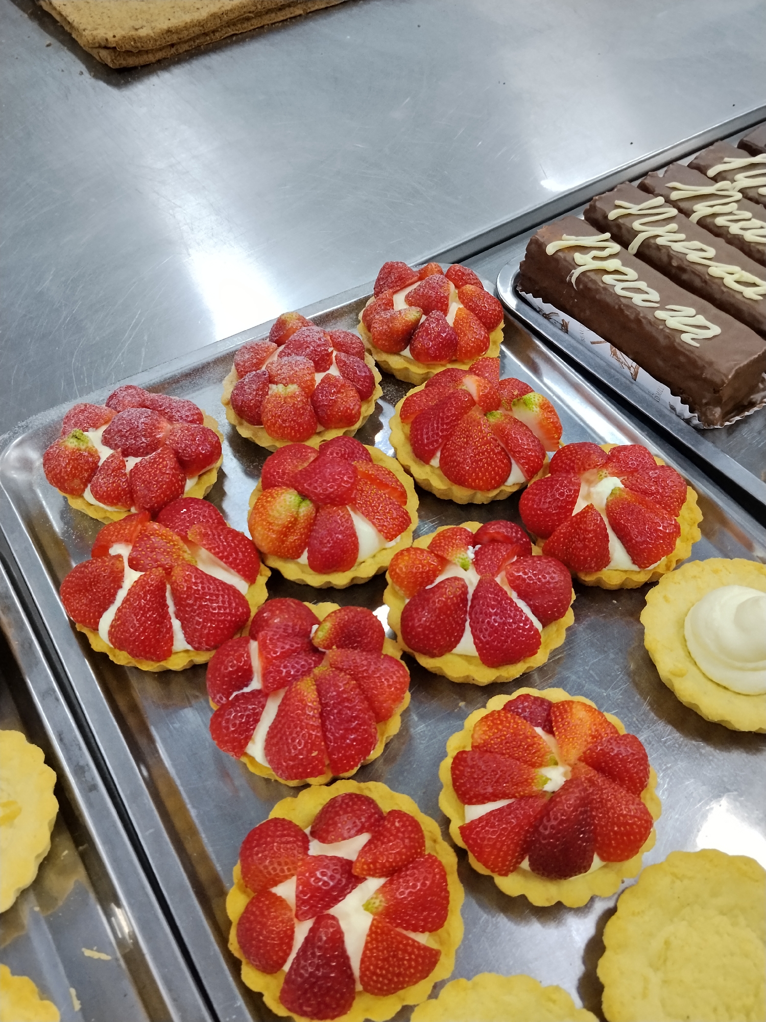 Bishkek bakery in full morning prep, pastries and fresh fruit everywhere