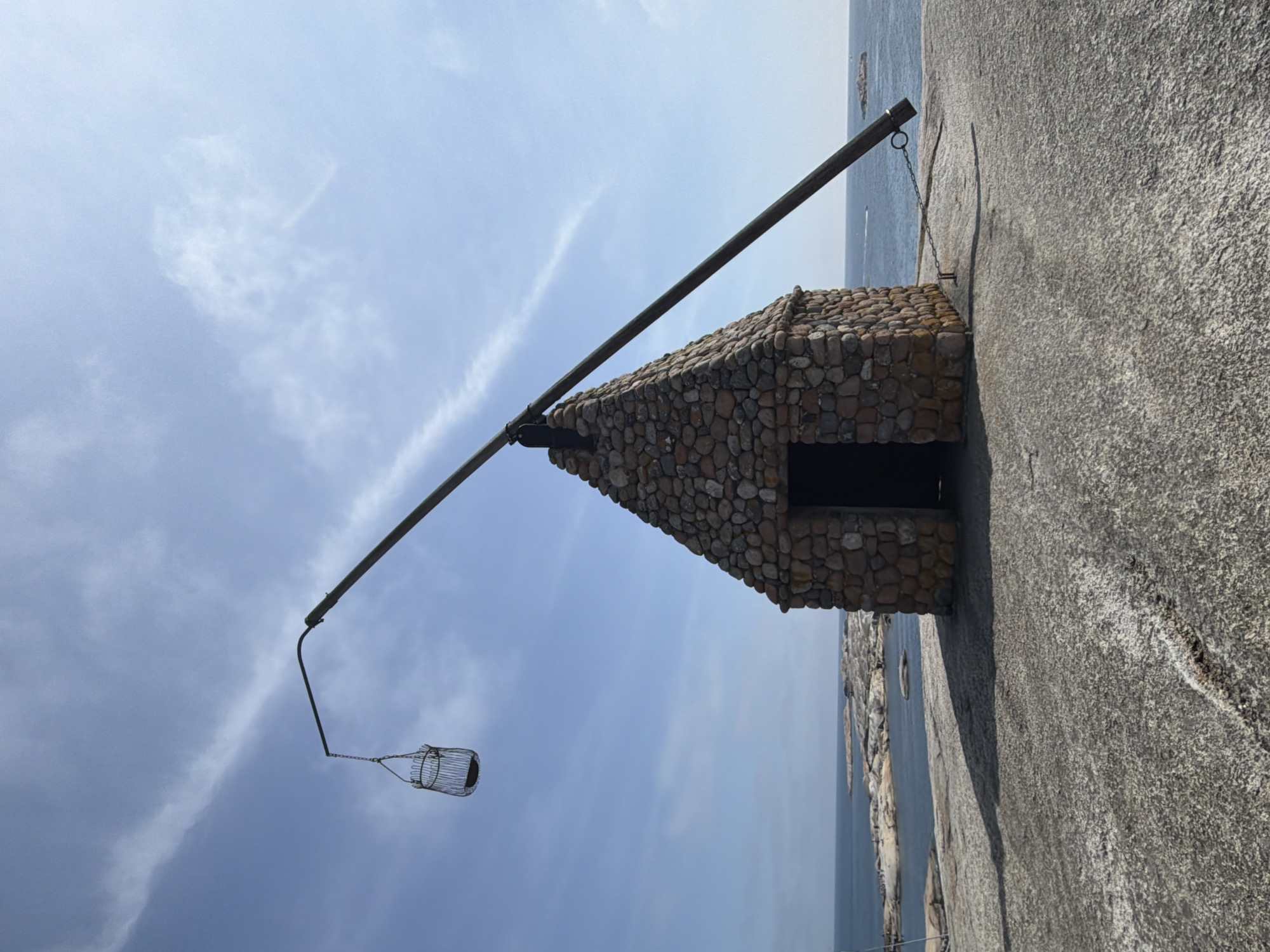 Stone beacon hut with suspended metal cage on Tjøme coast