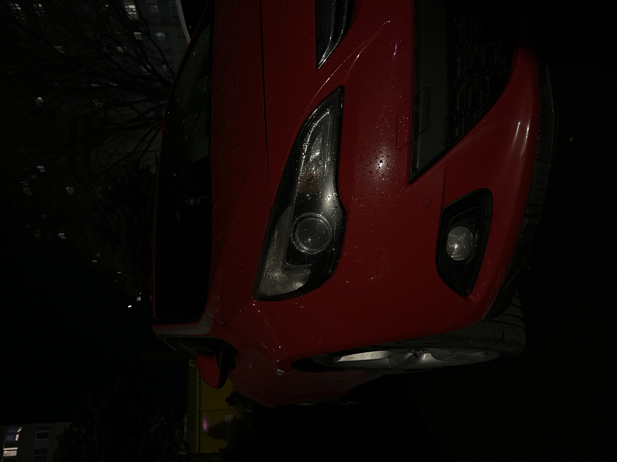 Red car parked on wet street in Russia