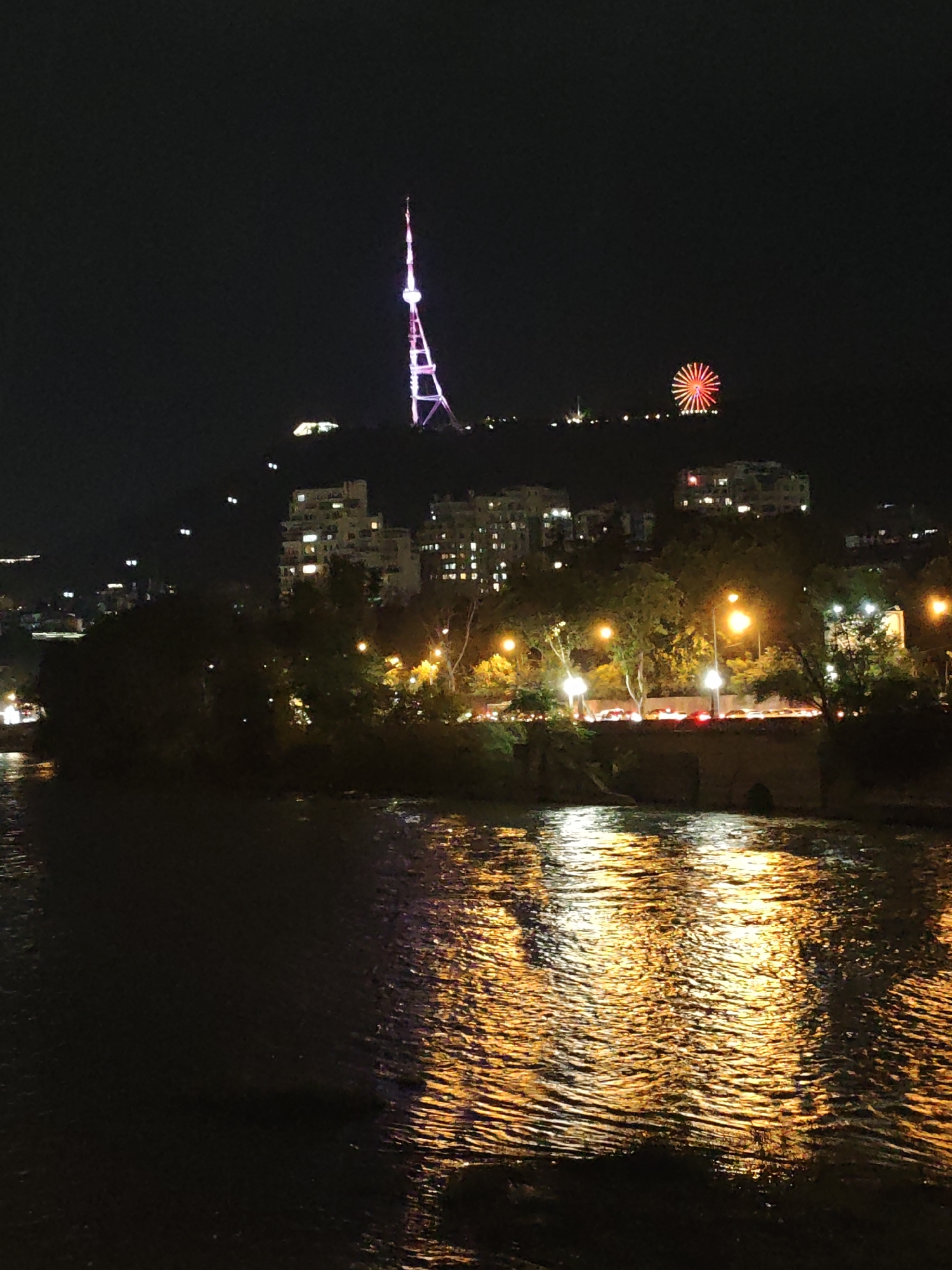 Tbilisi's Kura riverfront lit up on a summer night