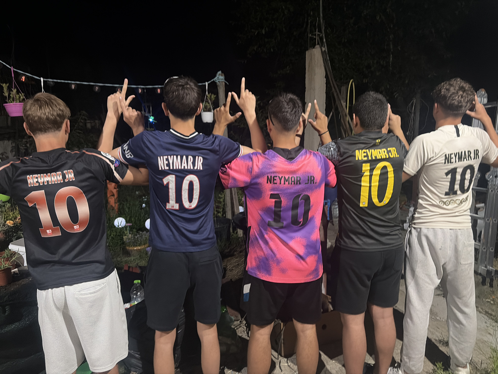 Soccer fans gather in rustic Bulgarian setting wearing jerseys
