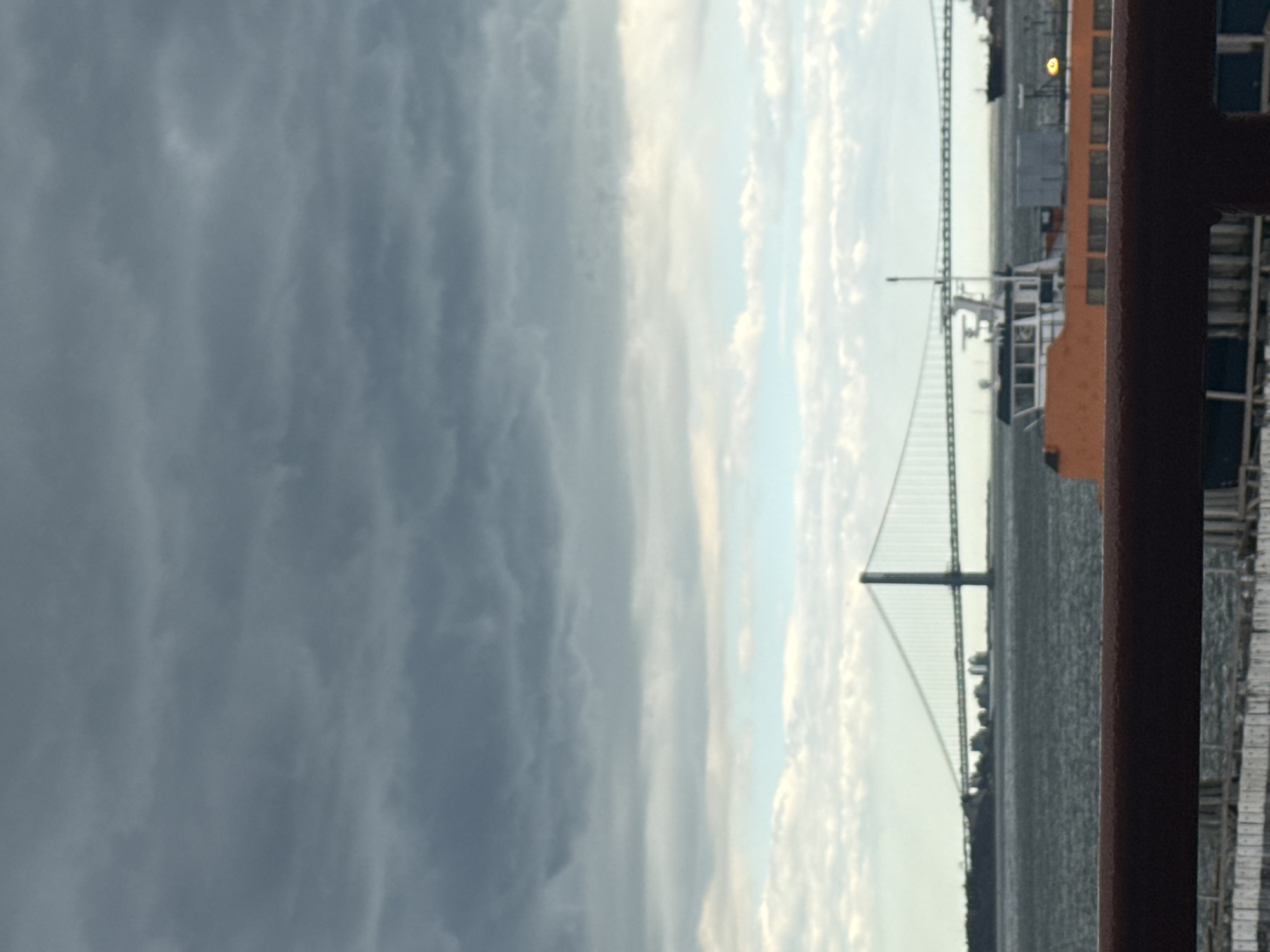 Ferry passenger photographs Verrazzano-Narrows Bridge from New York Harbor