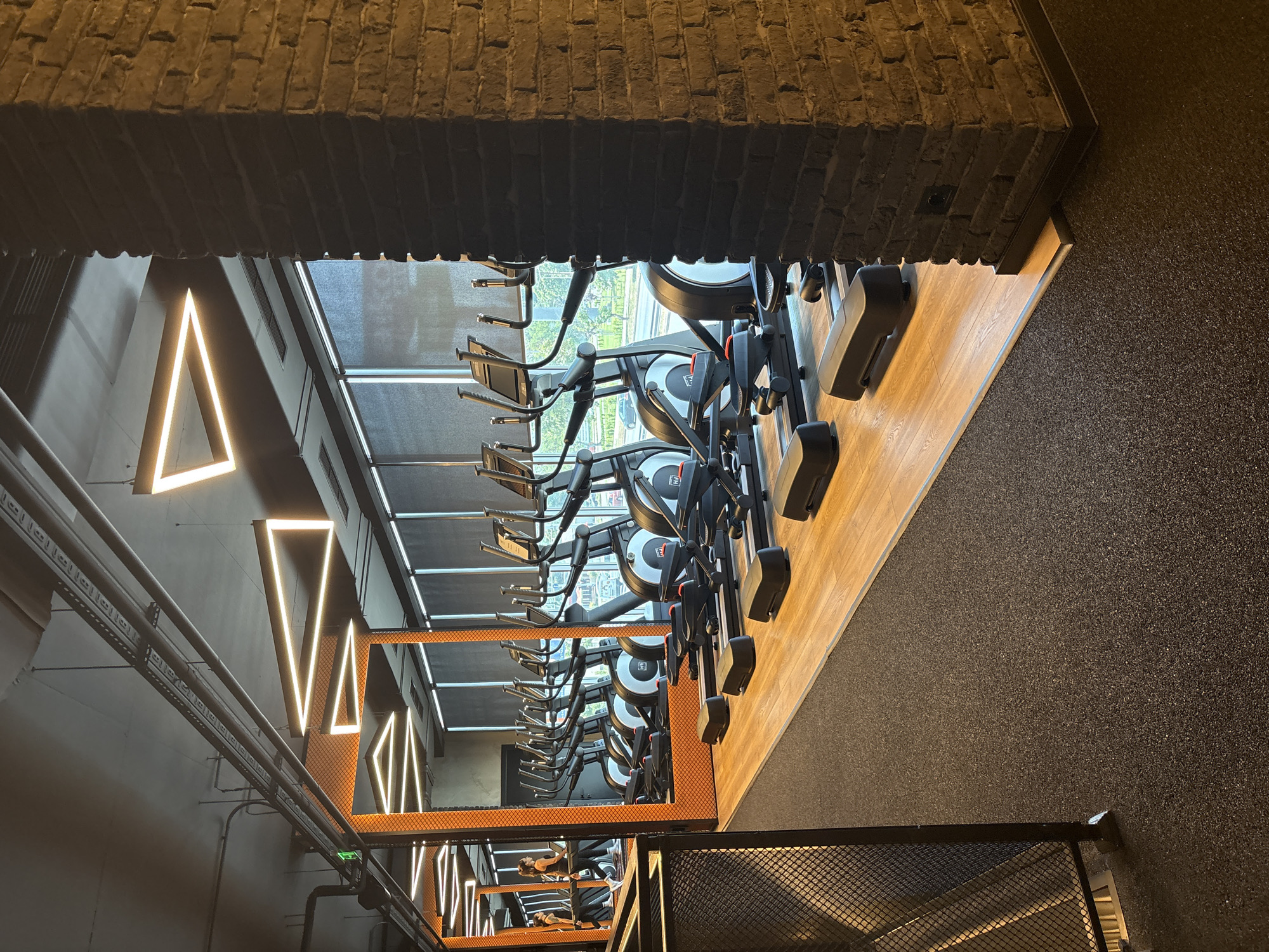 Inside a modern Plovdiv gym with cardio equipment and virtual ride screens