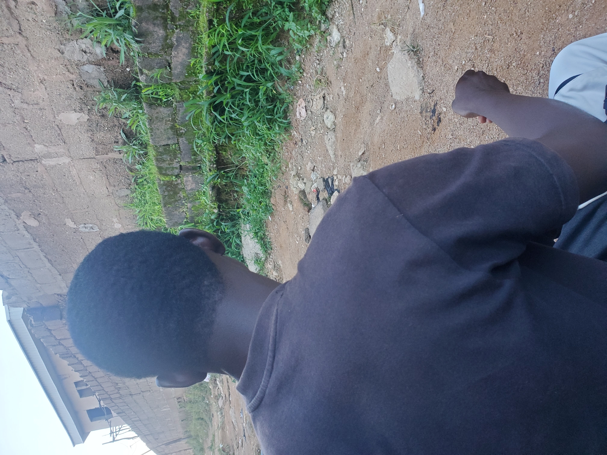 Daily life along rough dirt roads in a low-income urban area