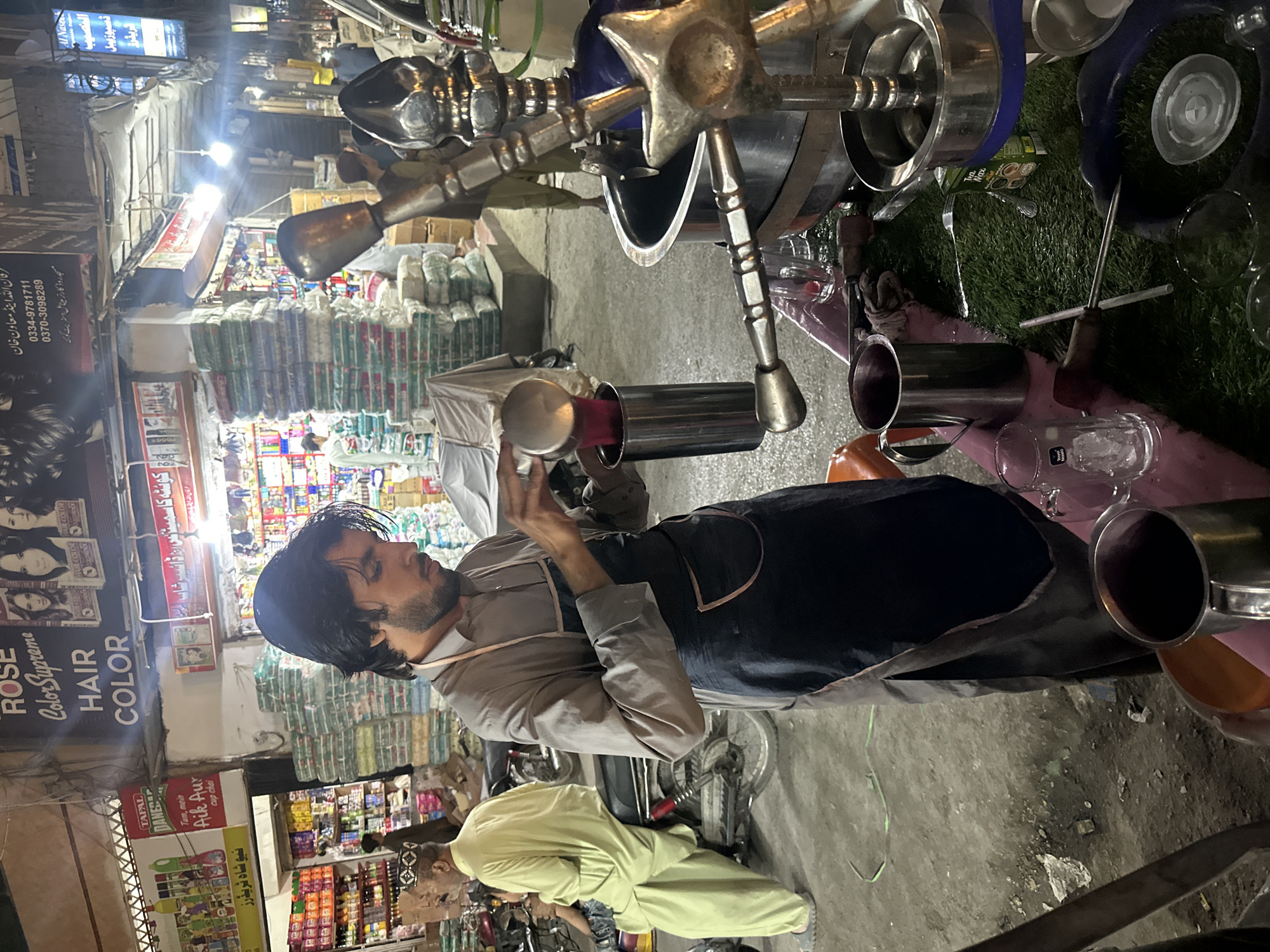 Street vendor serves drinks amid crowded scene in Quetta
