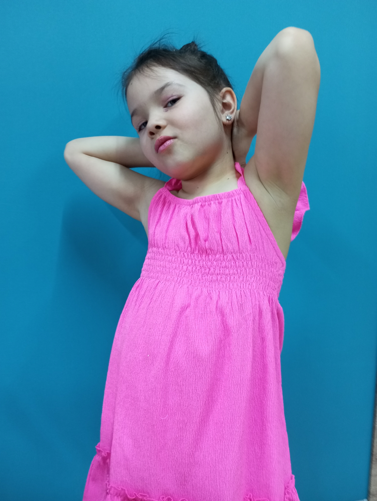 Girl in pink dress poses for photos in Pervomaysky home