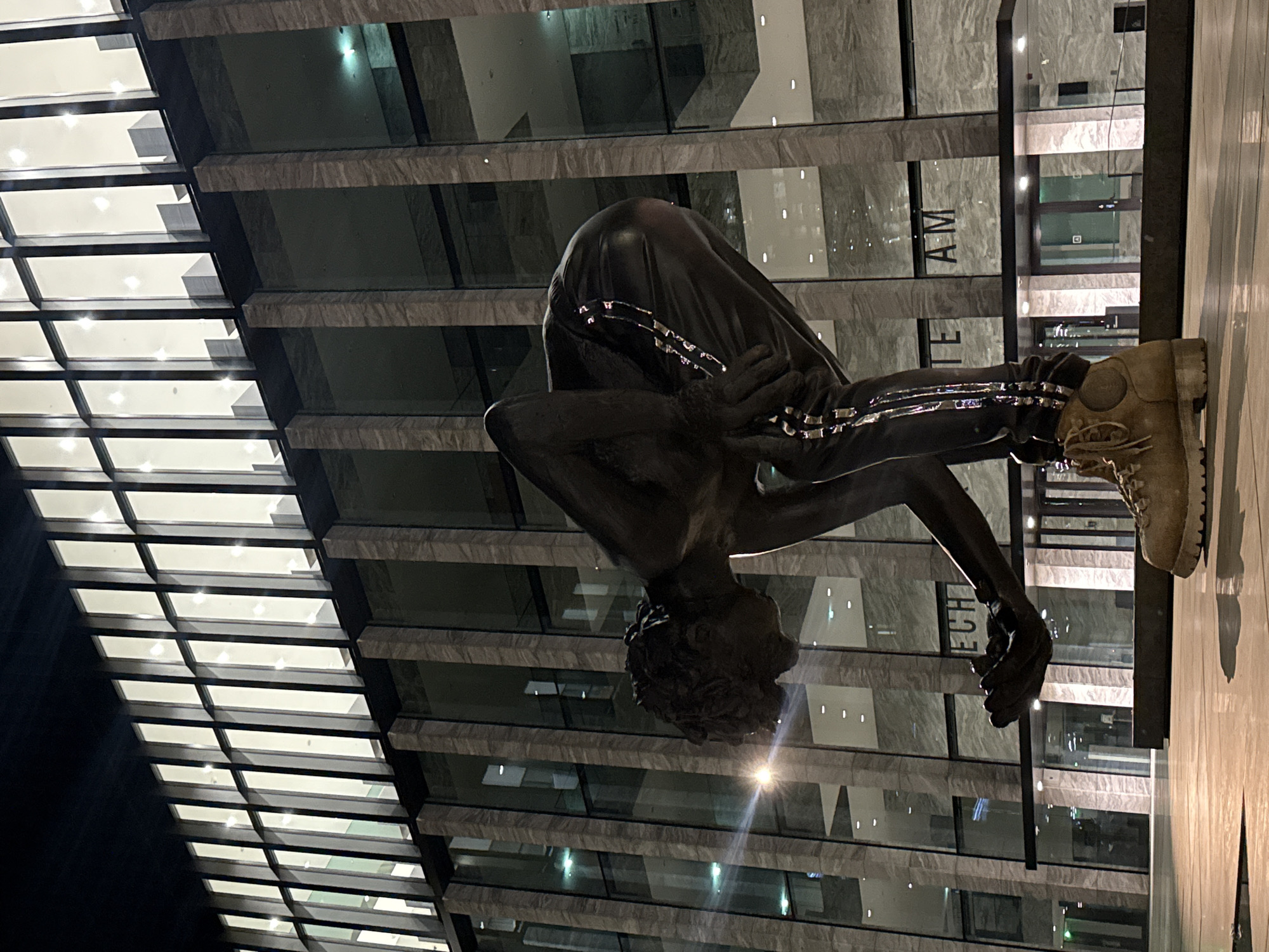 Bronze sculpture of crouching figure observed in Amsterdam
