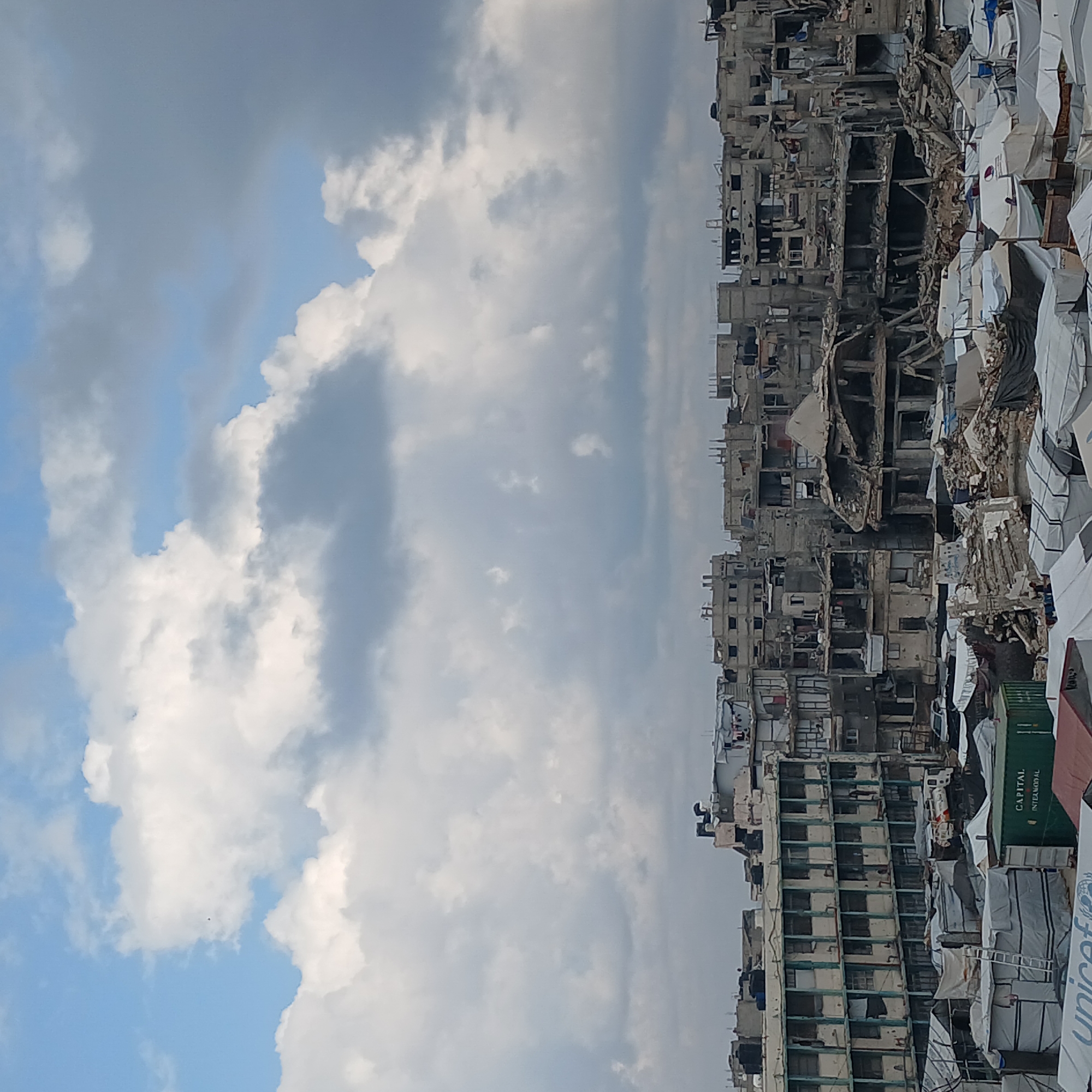 Gaza displacement camps, destroyed buildings, emergency food preparation documented