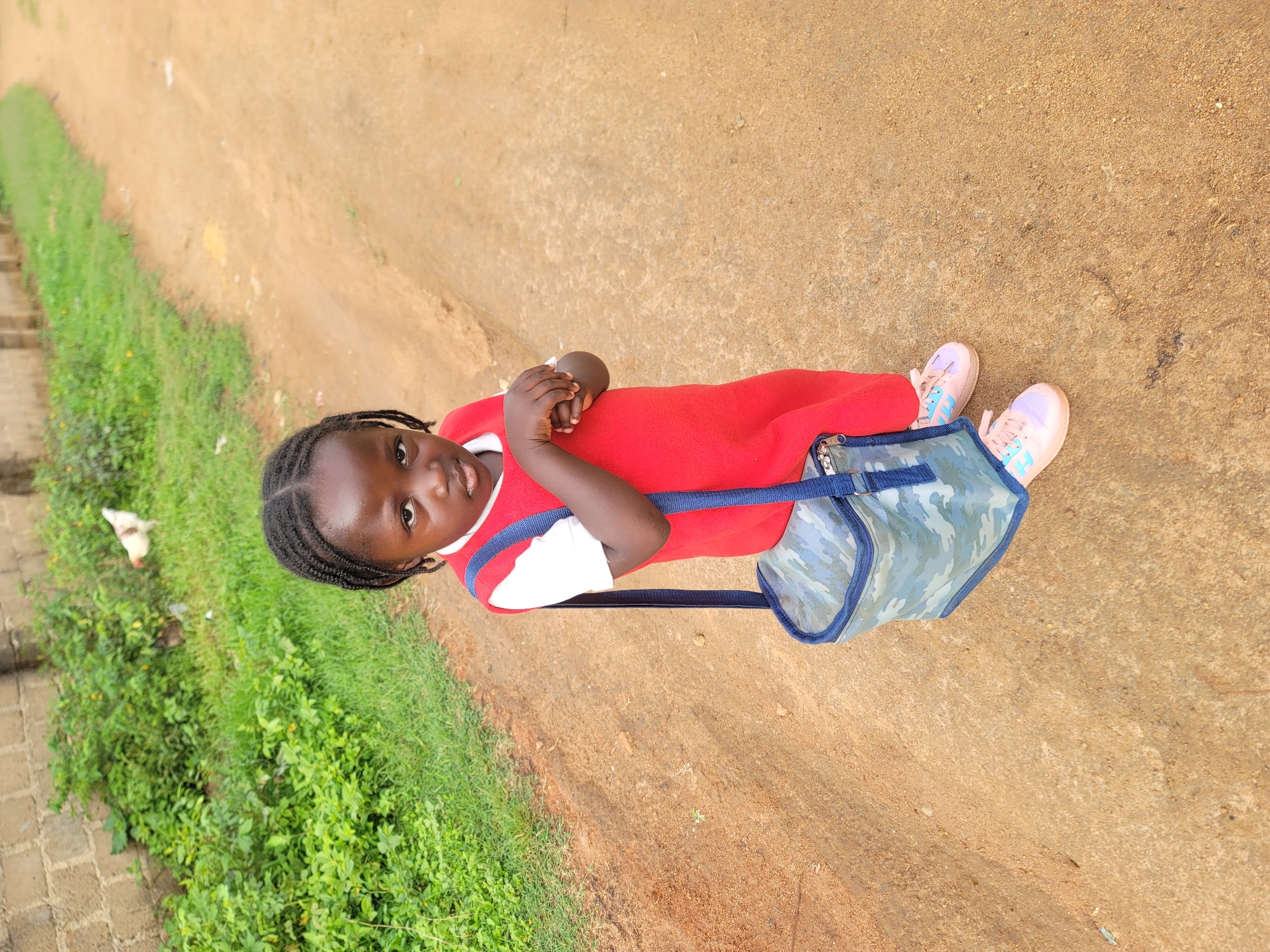 Morning school commute on a dirt path in rural Nigeria