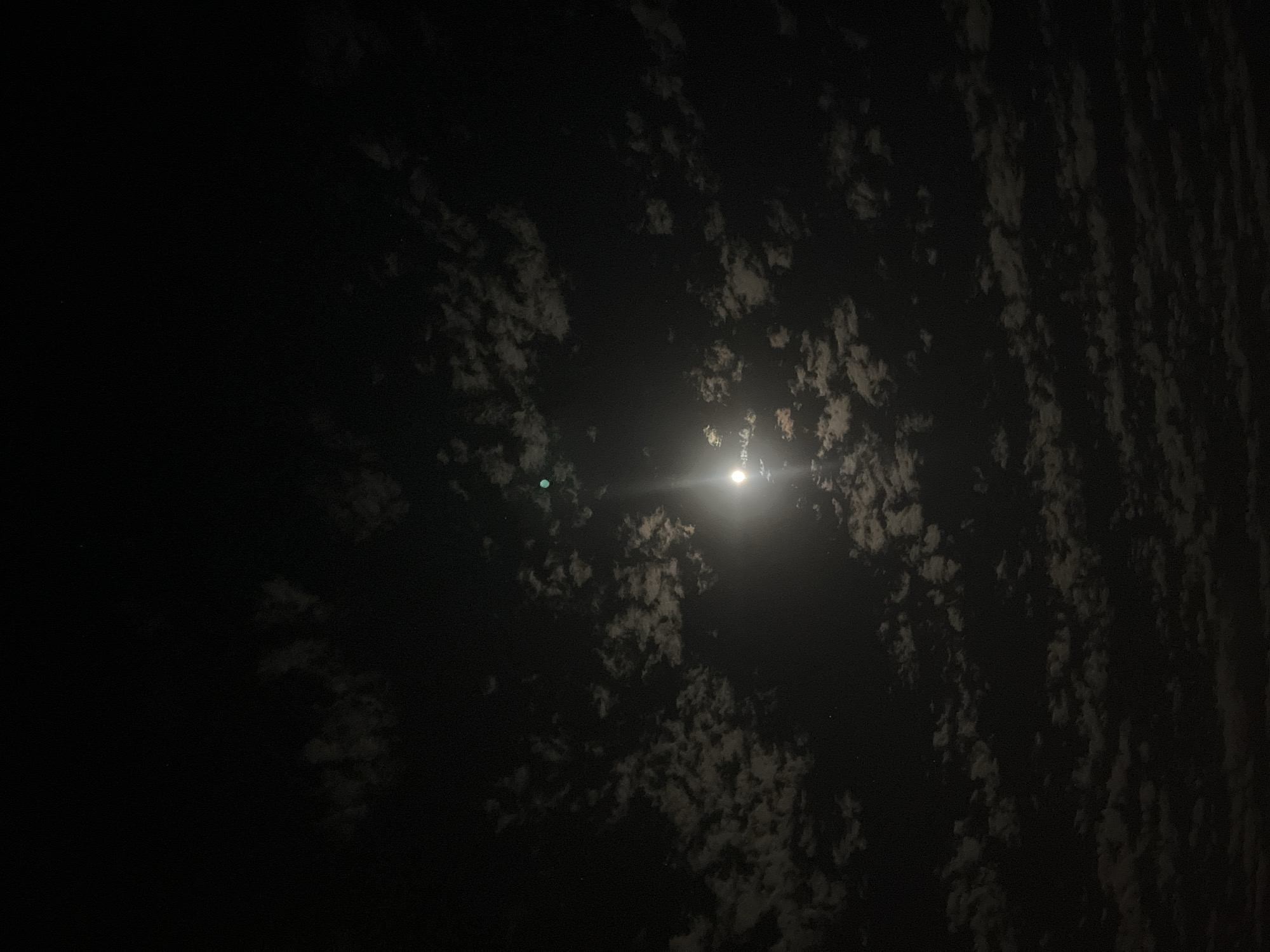 Nighttime construction activity observed under moonlit sky
