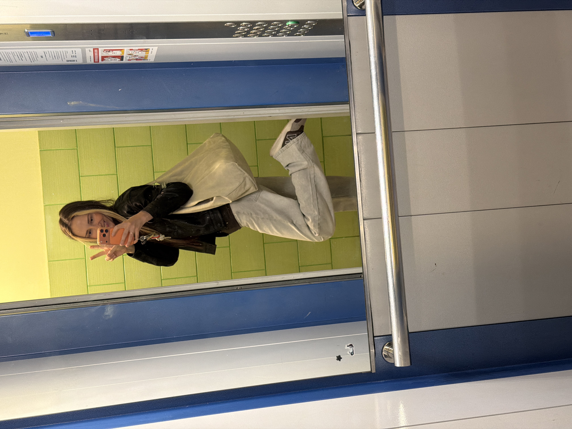Mirror selfie with an orange phone in Khimki