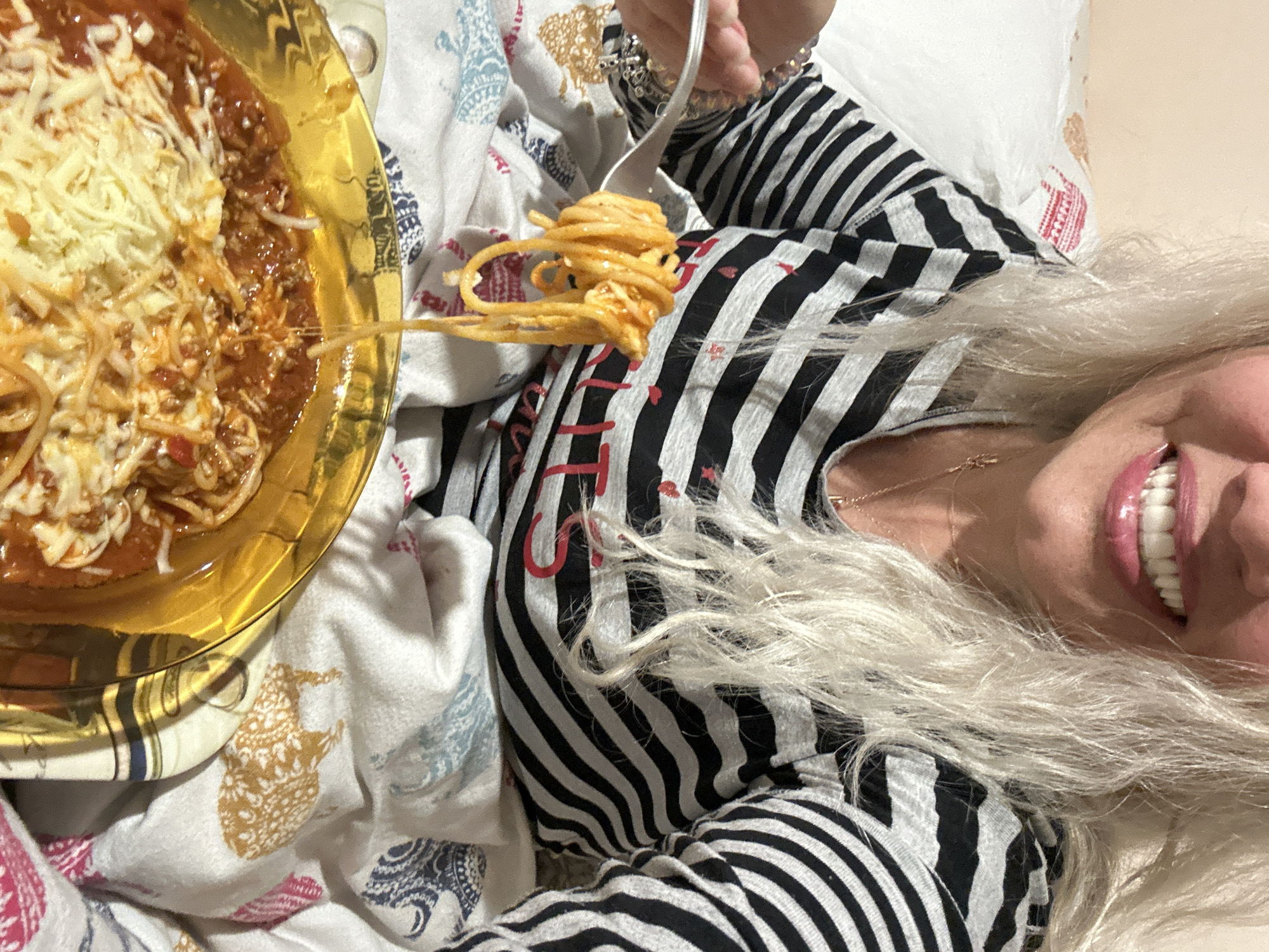 Woman enjoys spaghetti dinner with strawberries in Sofia