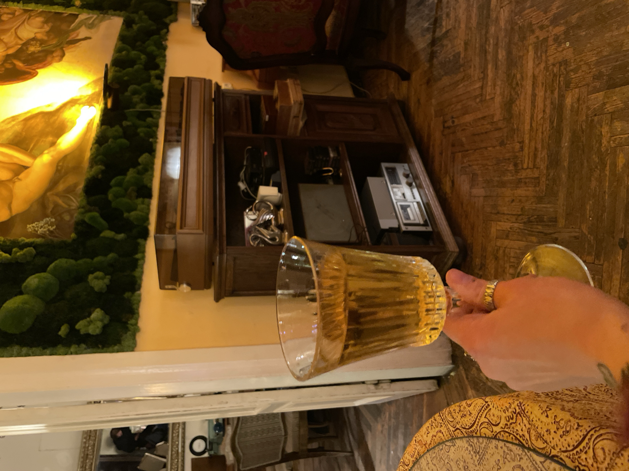 Person enjoys beverage at decorated dining table in Tbilisi